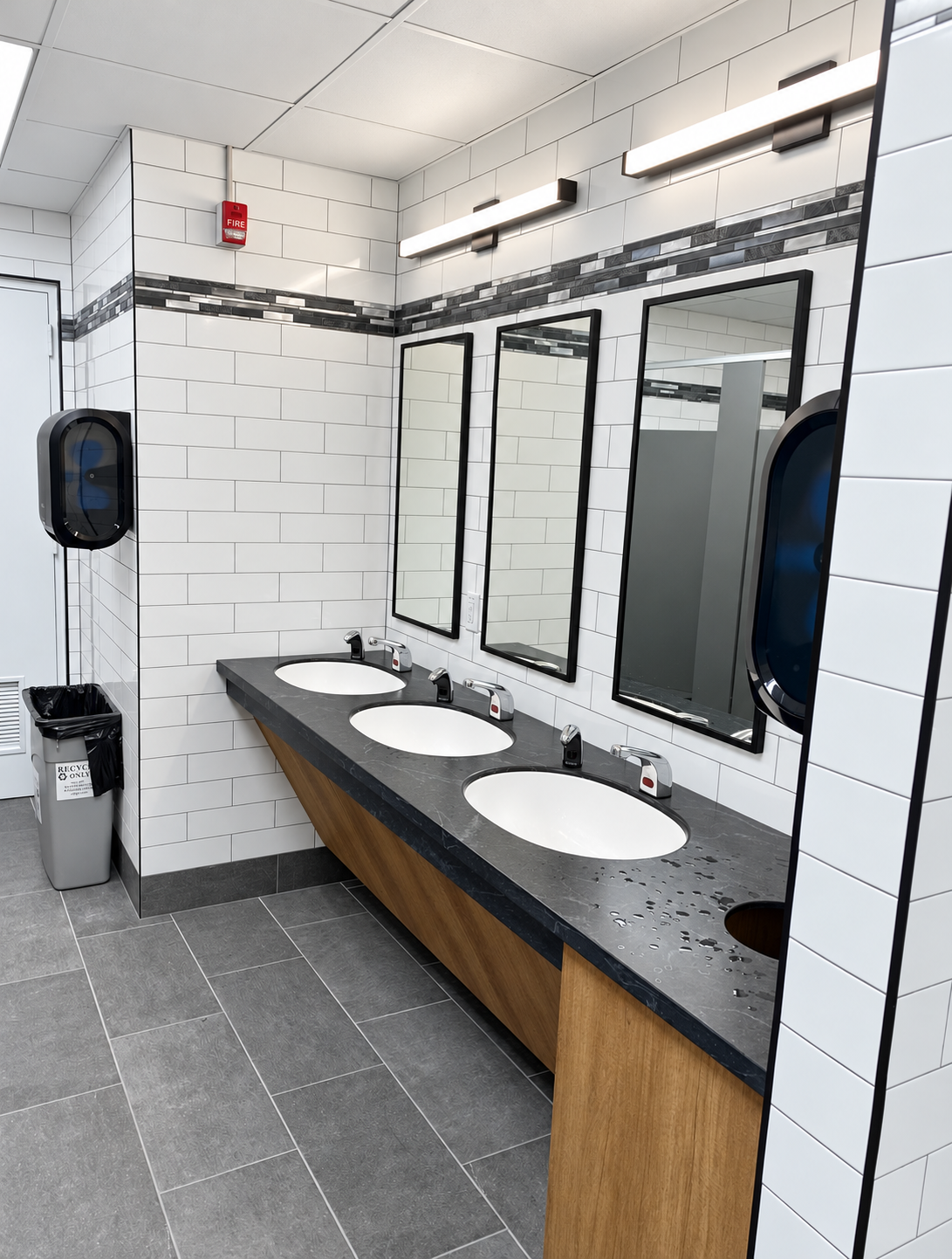 Completed commercial restroom renovation with tile finishes, corporate facility