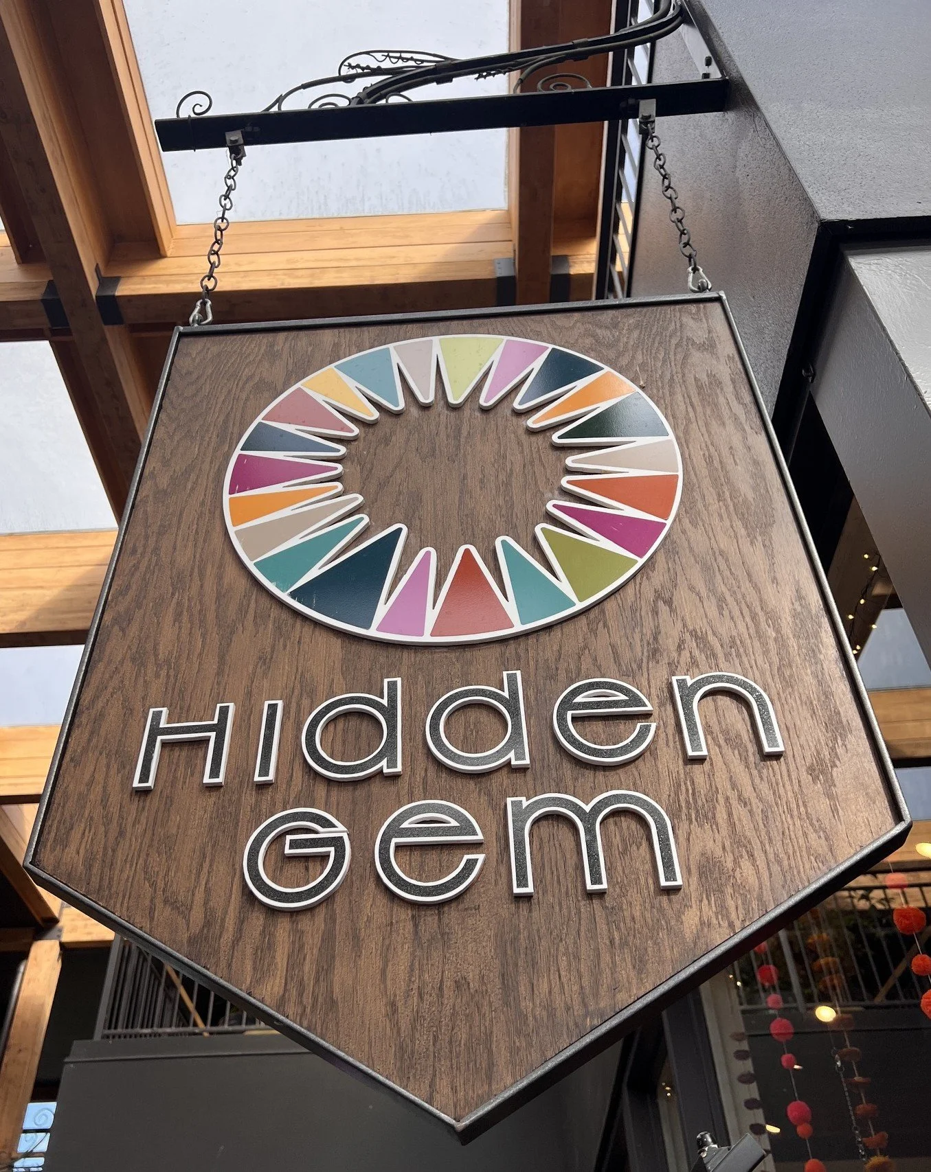 Custom wooden sign with raised lettering and custom metal frame.  