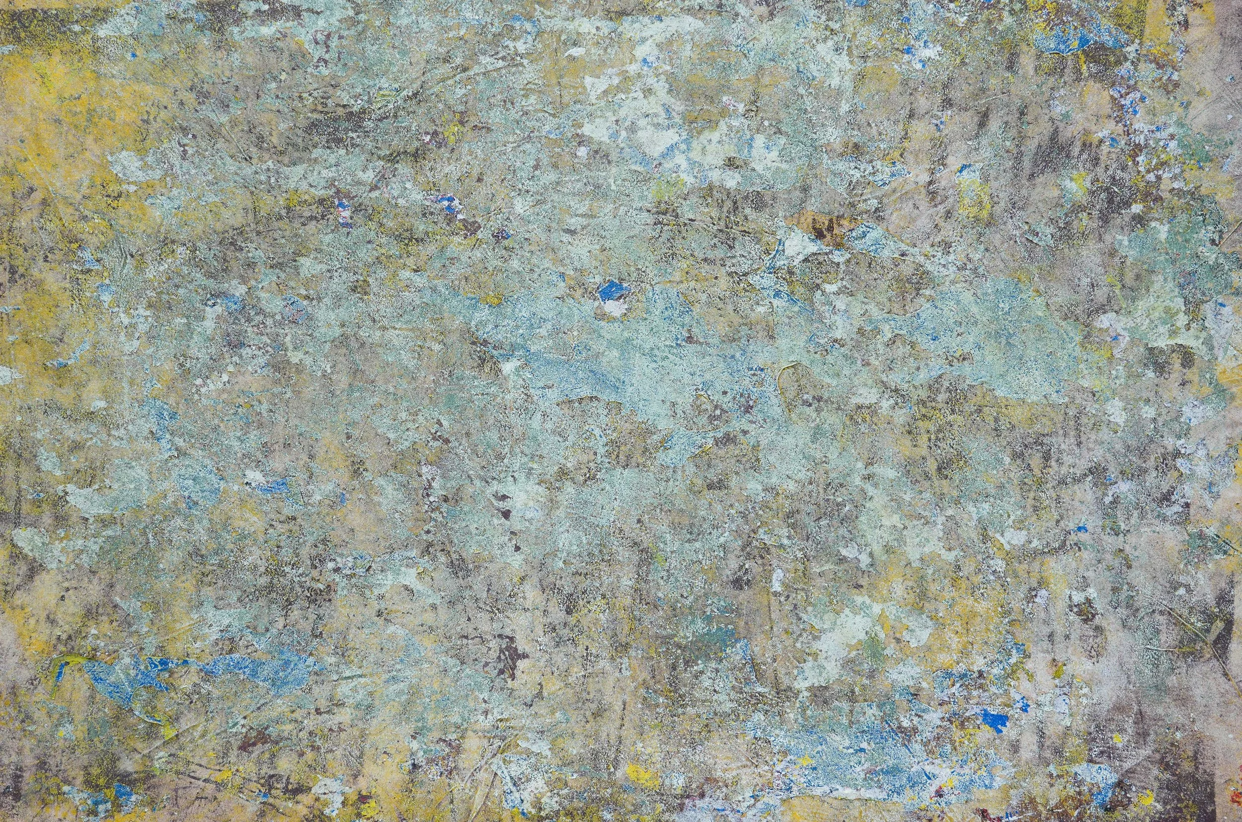 Abstract textured artwork with layered pale blue, gray, yellow, white, and brown paint.