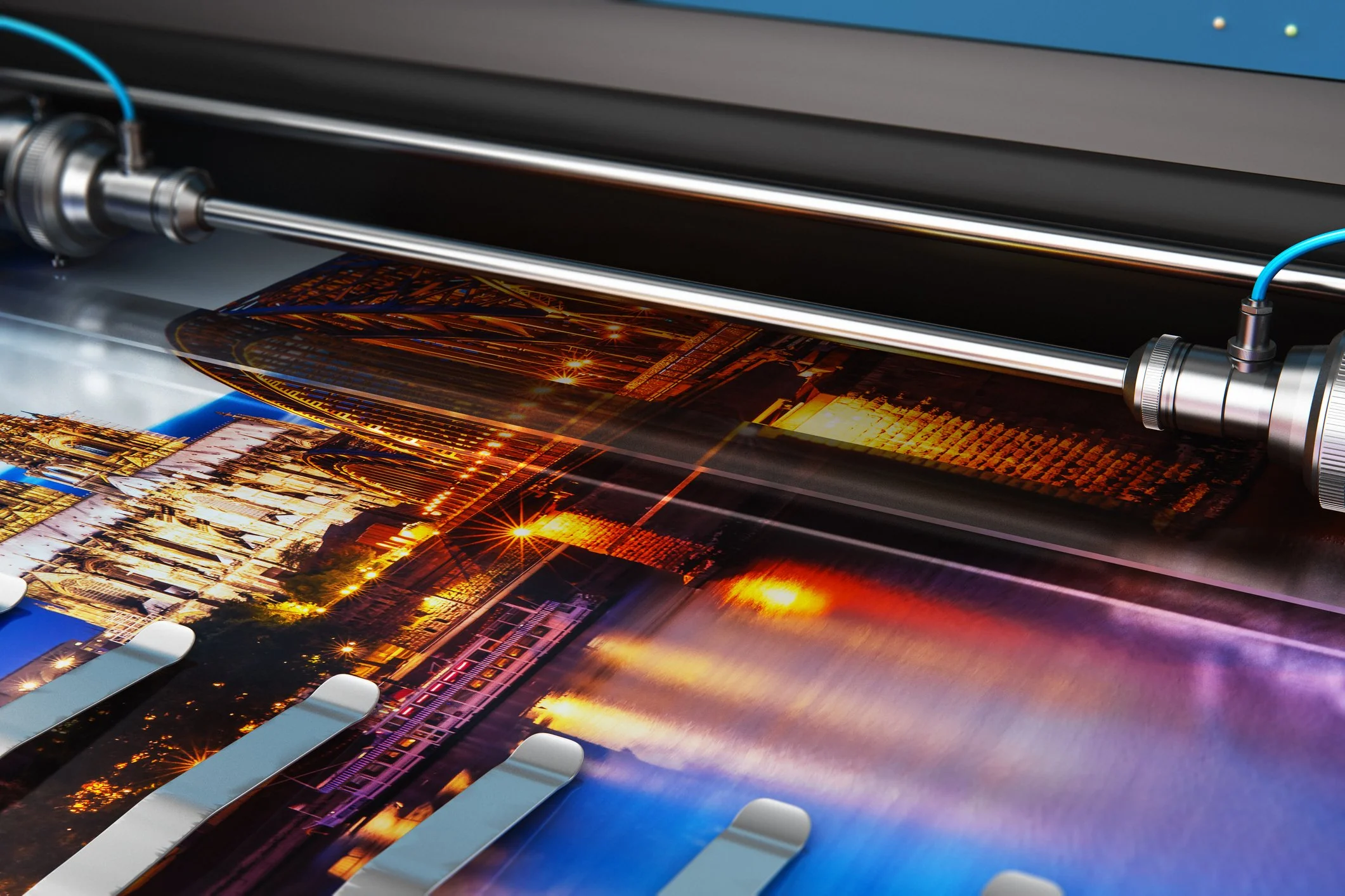 A large format printer printing a color image of a cityscape at night.