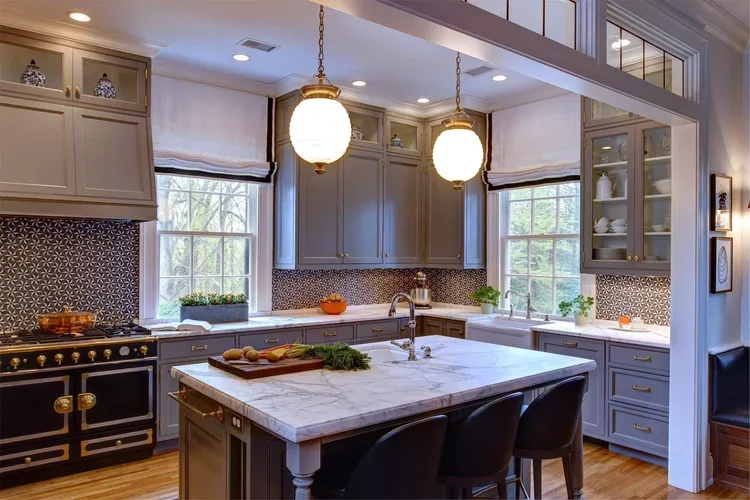 Cogswell Stone kitchen project with grey cabinetry and a veined stone island