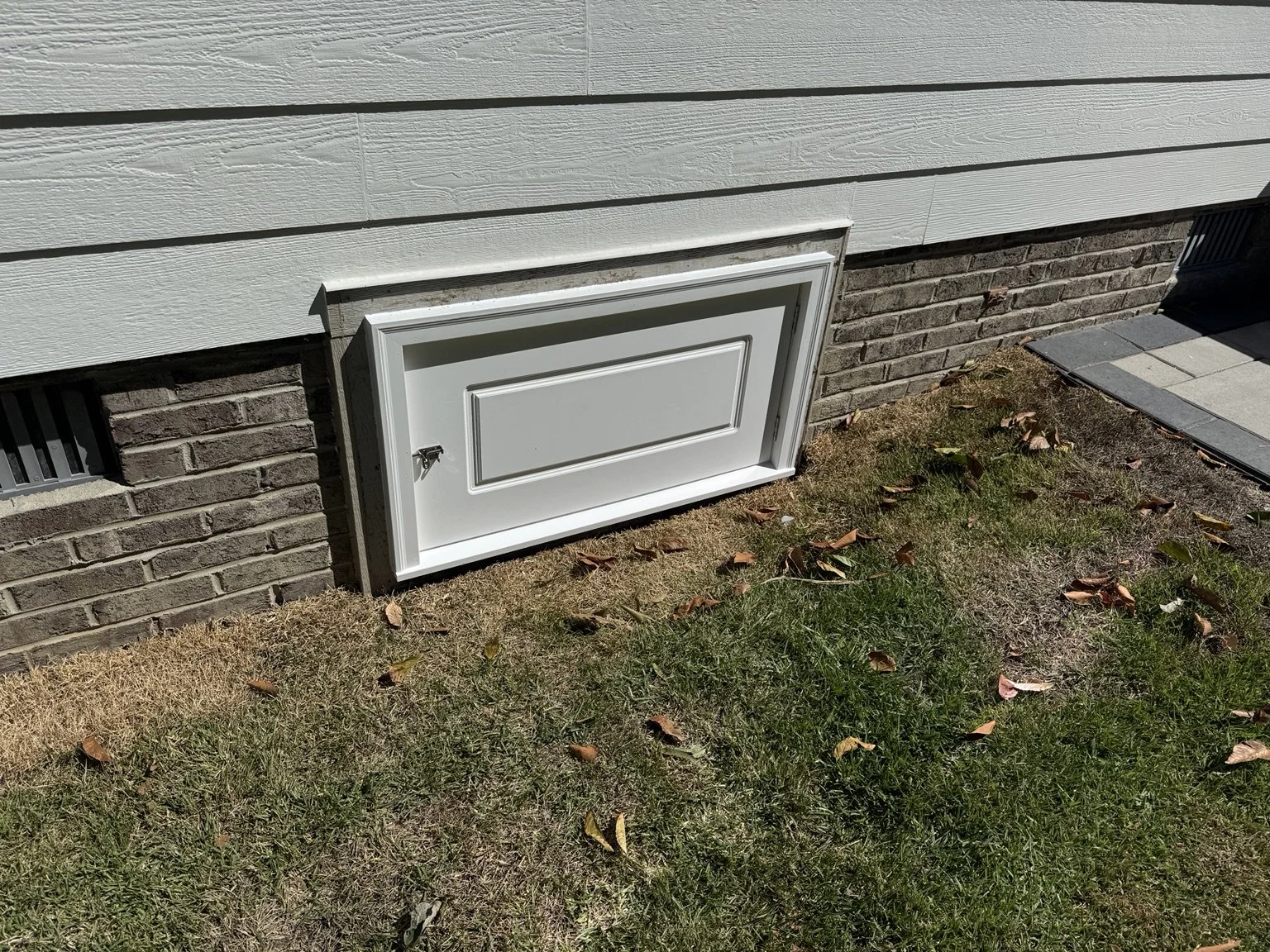 Even the smaller repairs deserve care. This replacement crawlspace door gives the opening a tidy finish and convenient access.