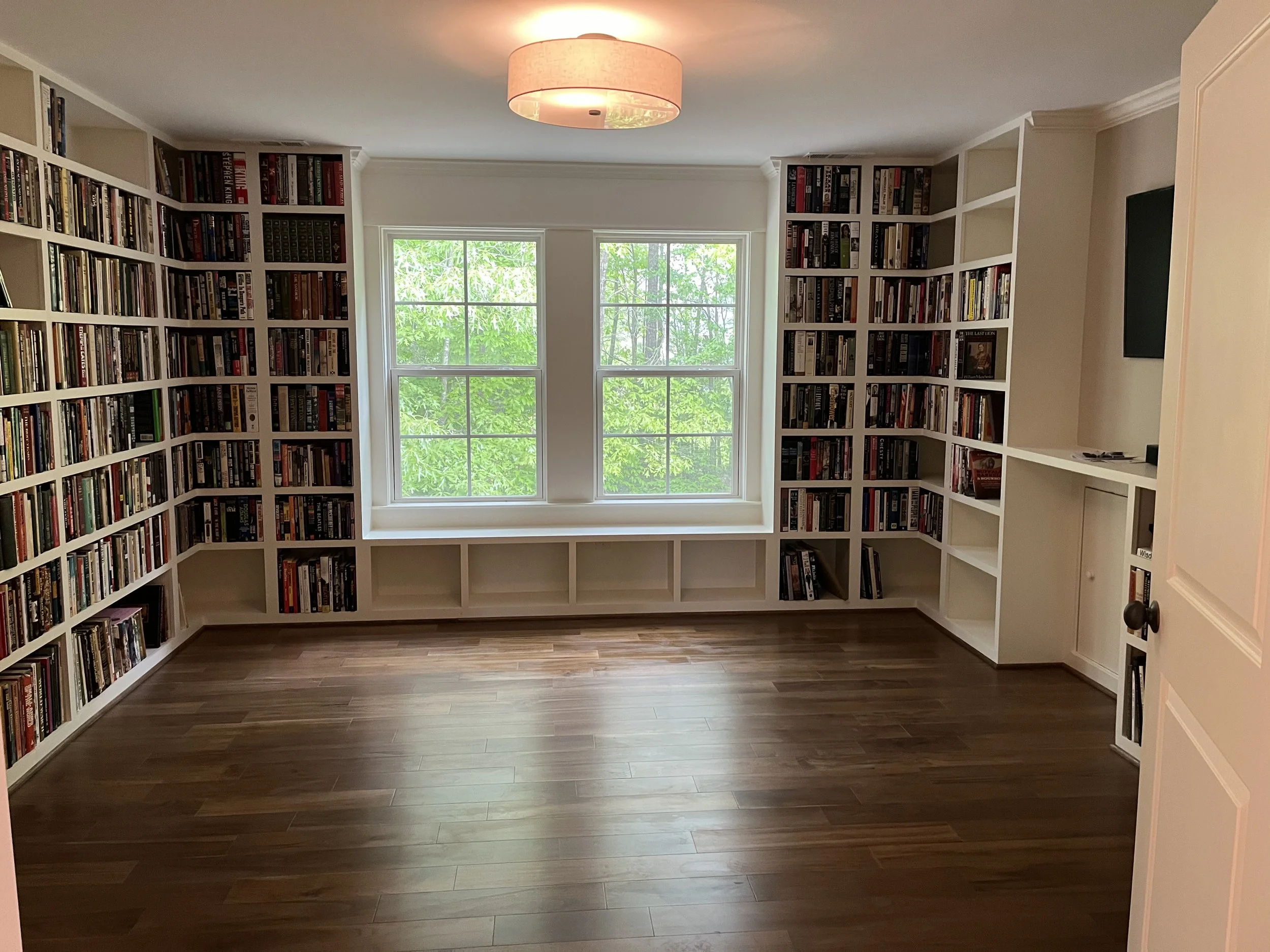Custom built-in bookshelves surround this sunny room with favorite reads and treasured keepsakes—a welcoming place to settle in with a good book.