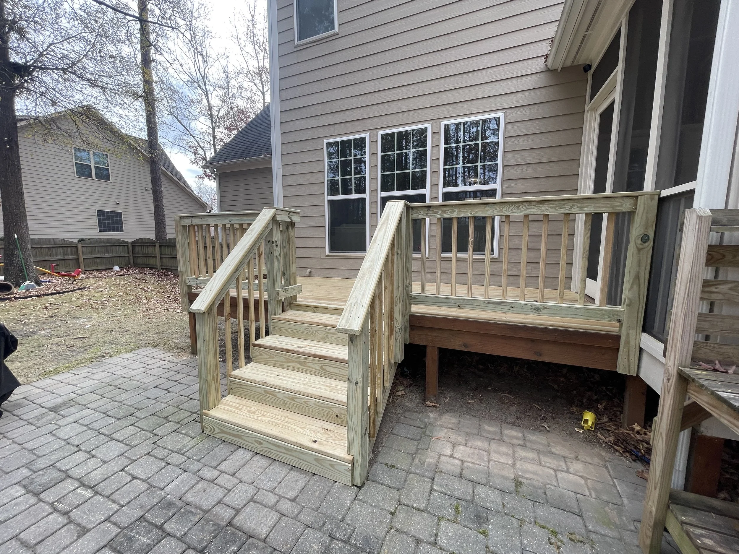 New wood steps and railings make the patio feel like a natural extension of the deck, ready for more time outside.