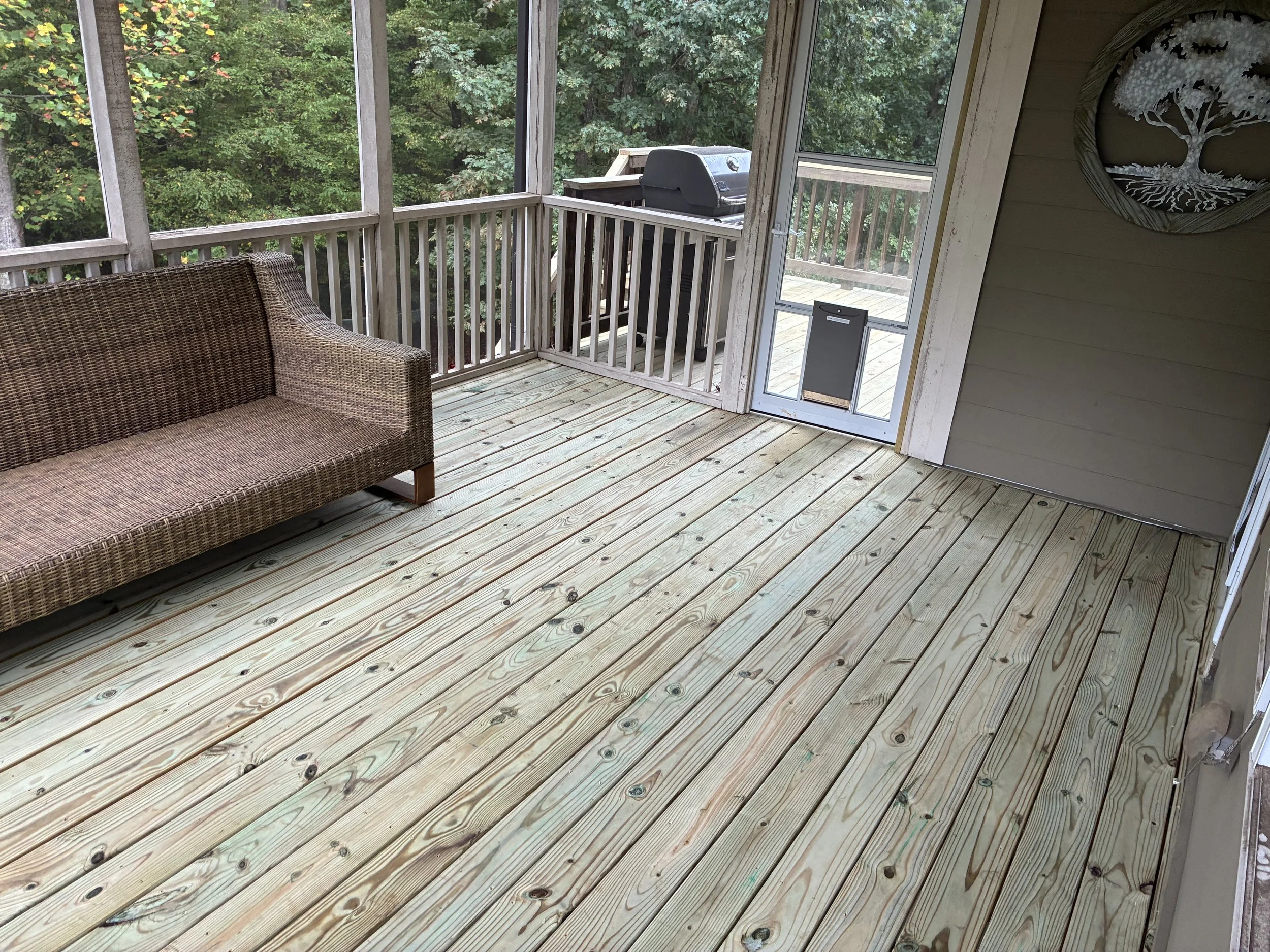 Fresh decking makes this porch an inviting spot for morning coffee or an easy afternoon outdoors.