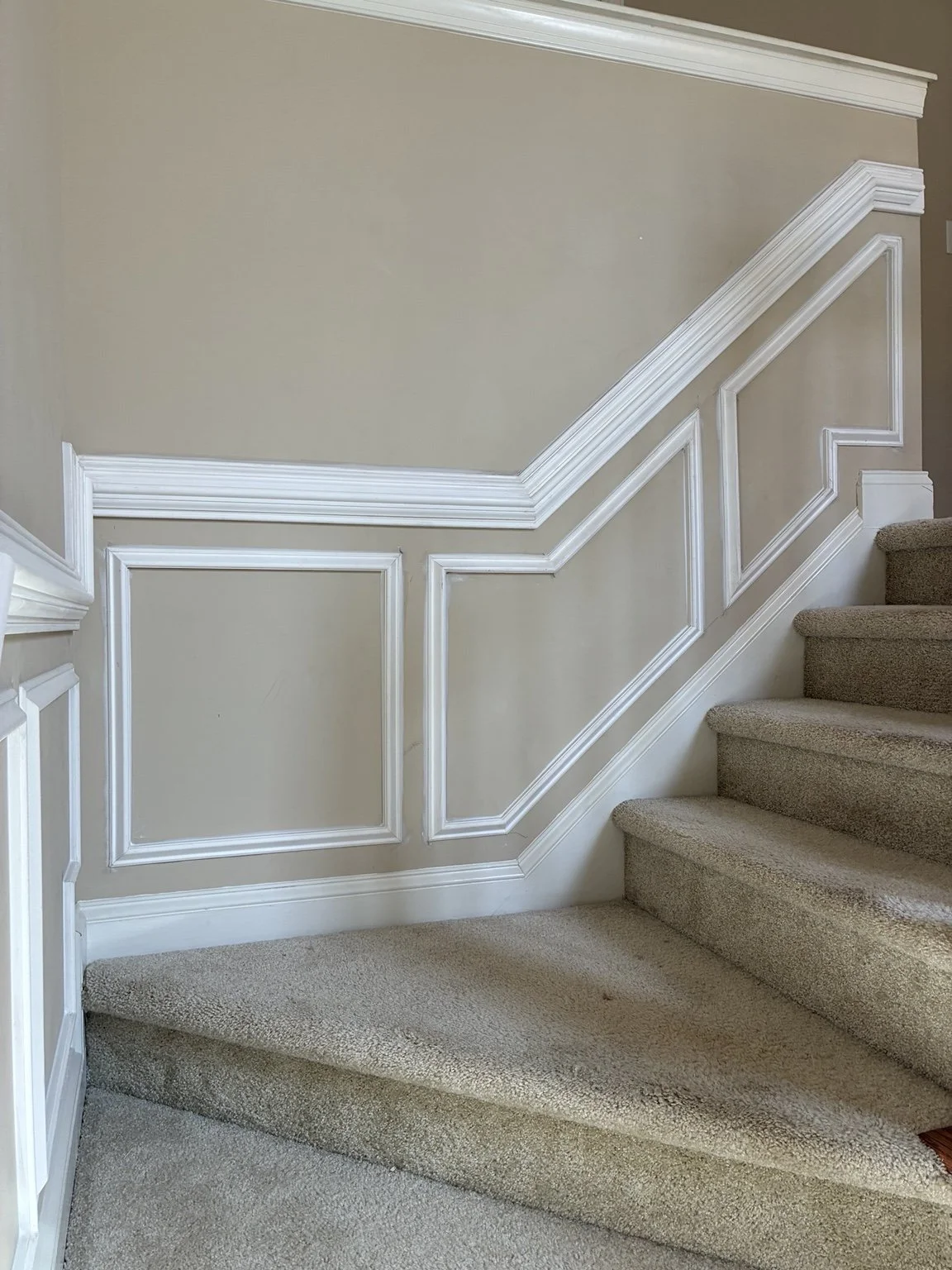 White trim follows the staircase and landing, adding character and a finished feel to a part of the home you pass through every day.