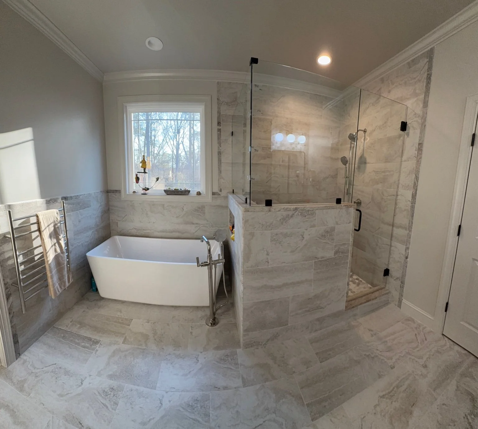 Matching tile brings the tub and shower together, creating a comfortable space with room to unwind.