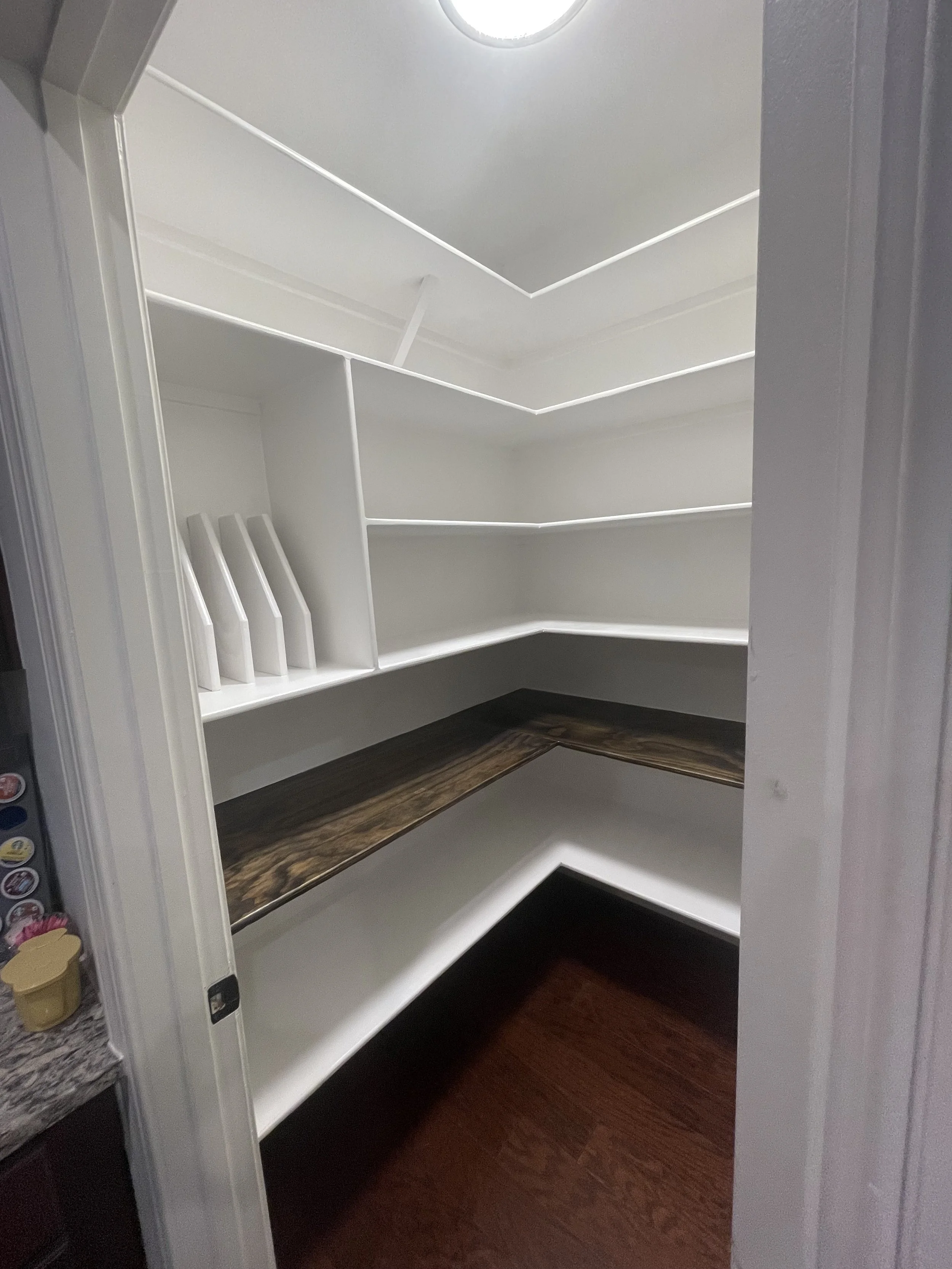 Open shelves and a place for trays help keep pantry staples easy to find, so there is a little less searching and more time for cooking.