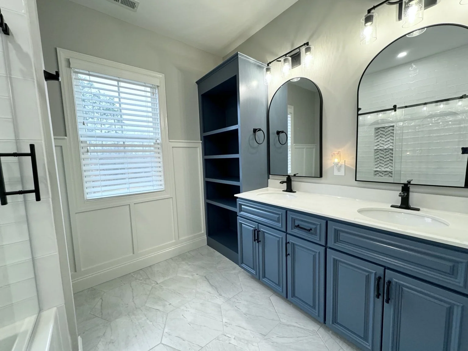 A deep blue double vanity gives everyone a little room of their own, with plenty of storage to keep busy mornings feeling more relaxed.