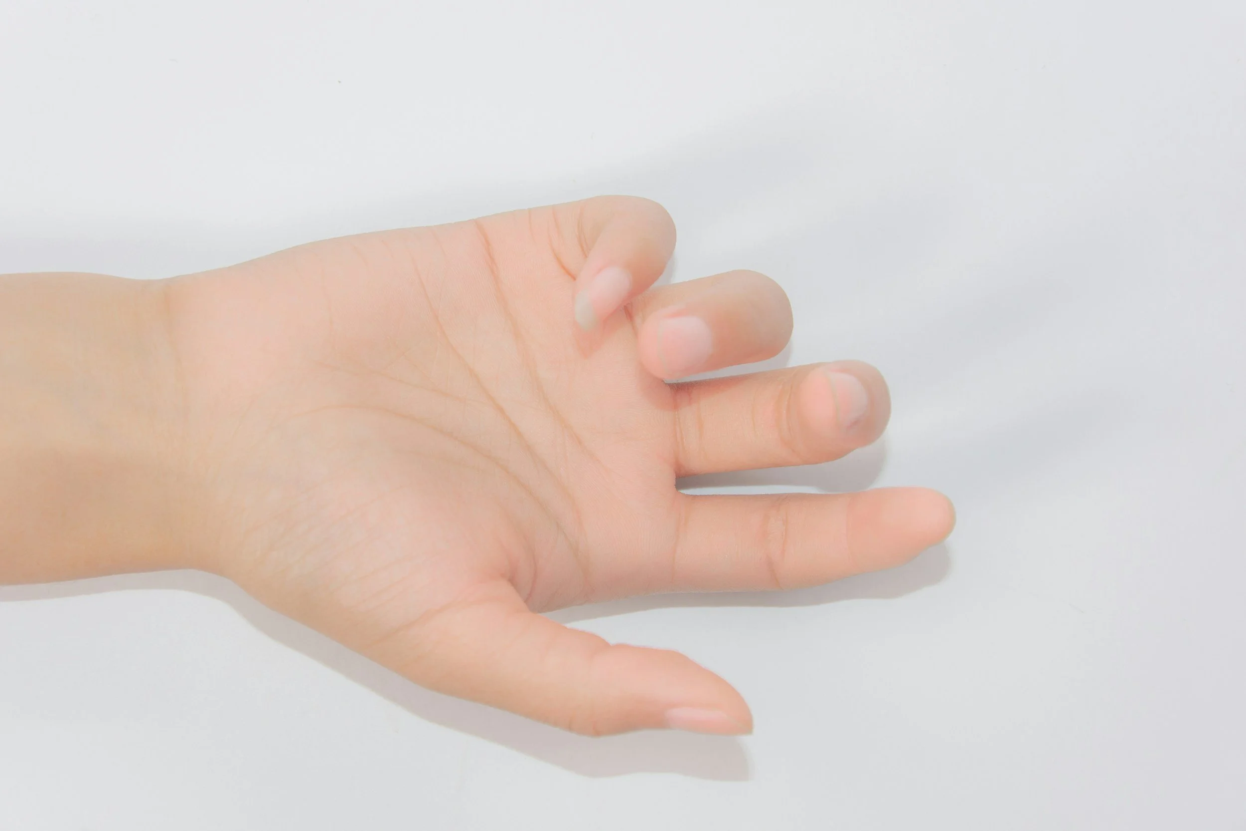 A human hand with fingers slightly spread against a plain white background.