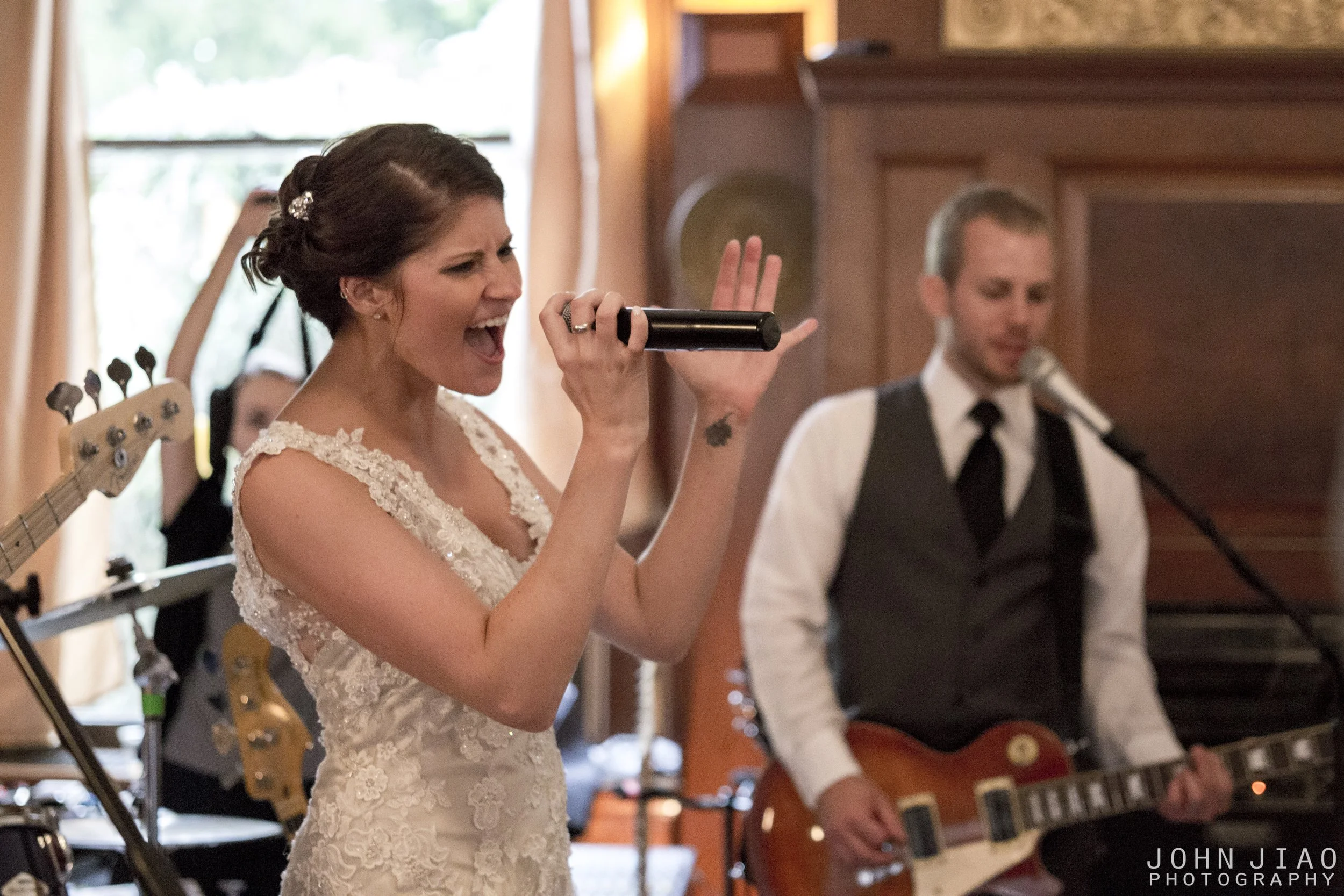 Wedding photo showing bride and groom playing and singing in a band, by Dr. John Jiao