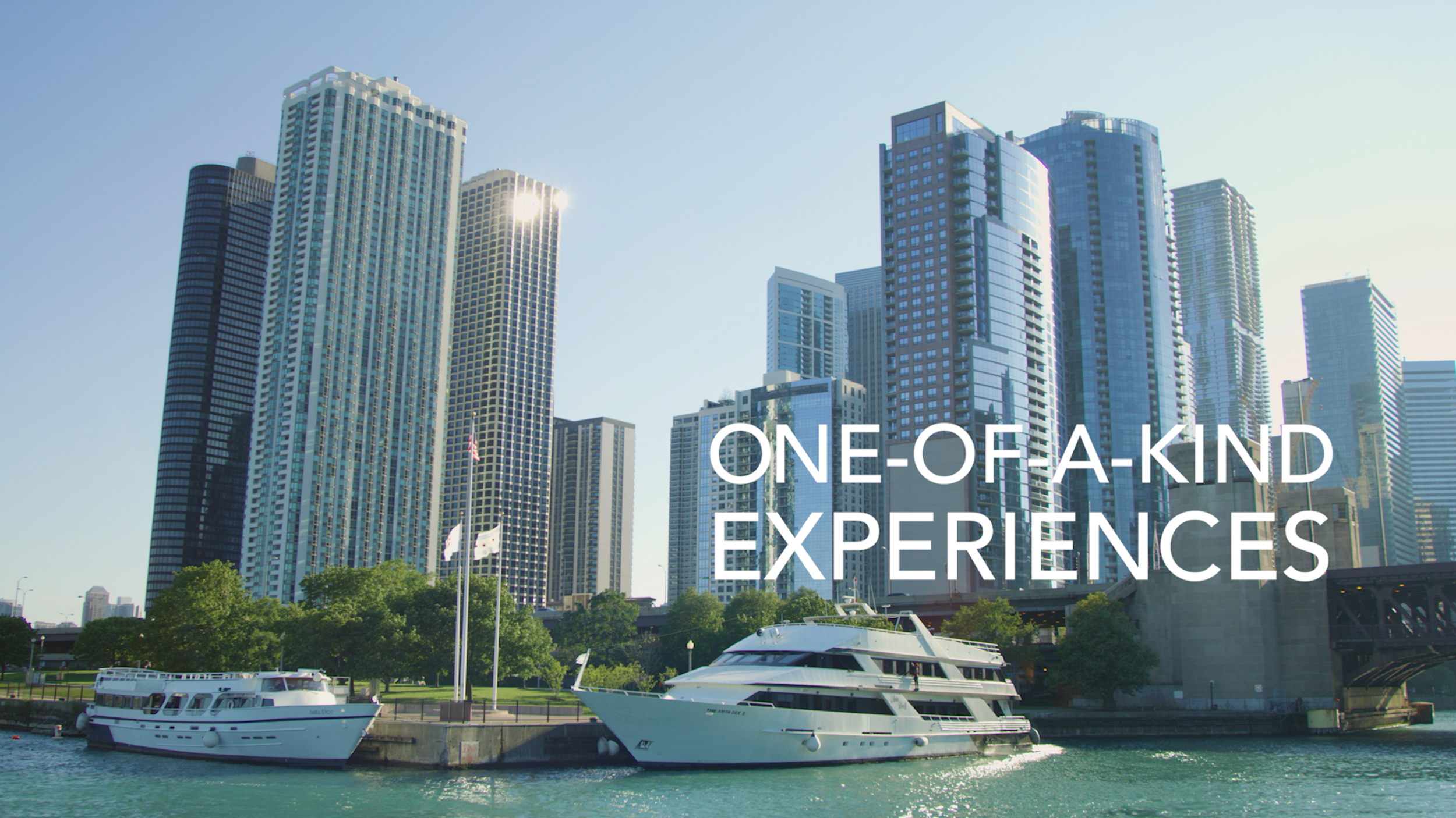 A city skyline with tall modern skyscrapers and a marina with boats, under a clear blue sky, with the text 'One-of-a-kind experiences' overlayed.
