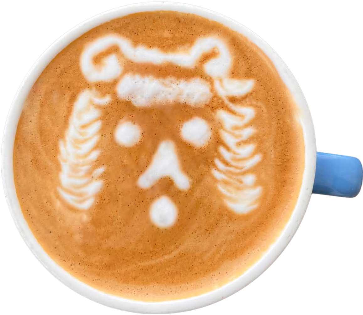 Top-down view of a lion latte art in a cup with blue handle.