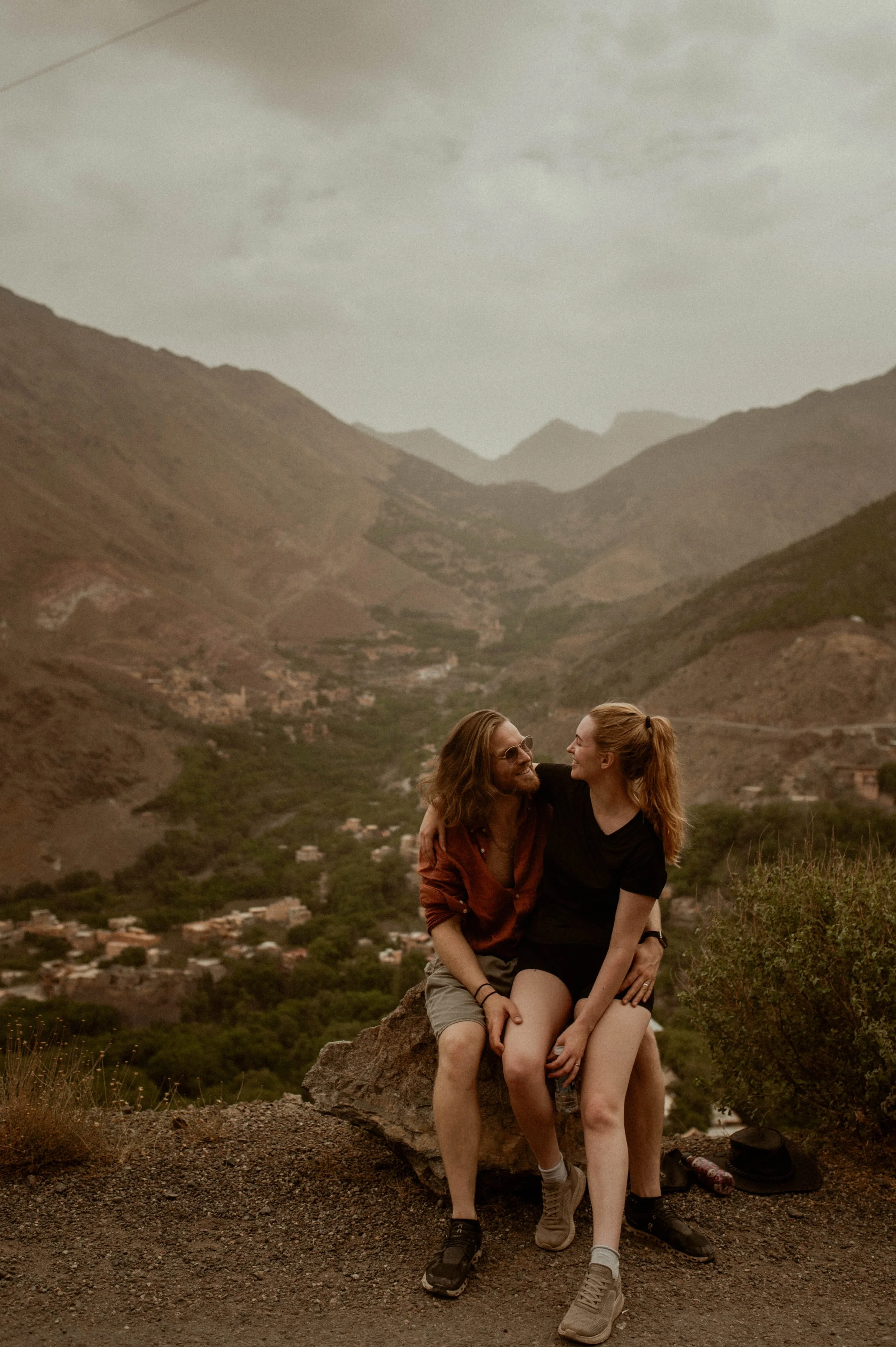 A DINK couple sitting together on a rock in Imlil Morocco