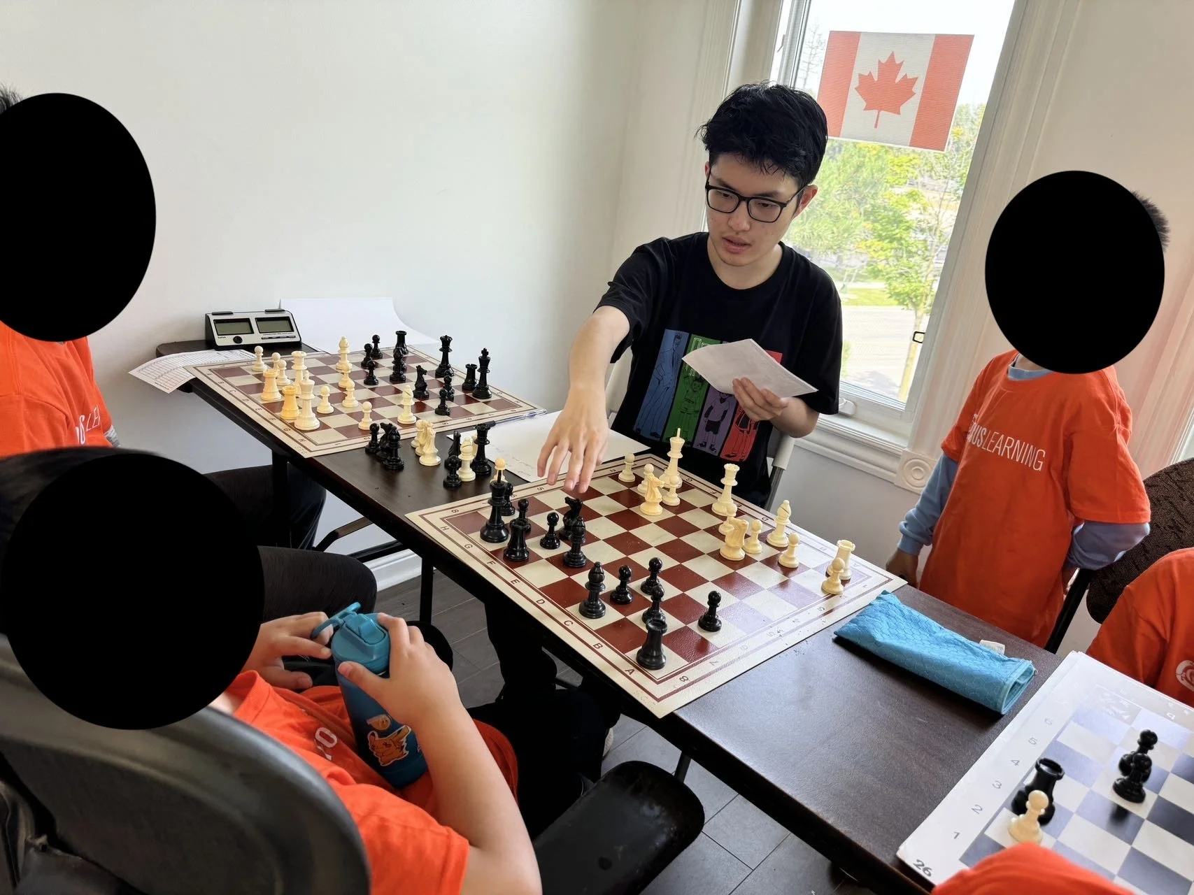 Jeffrey Xu (coach Jeff) analyzing a chess game with students