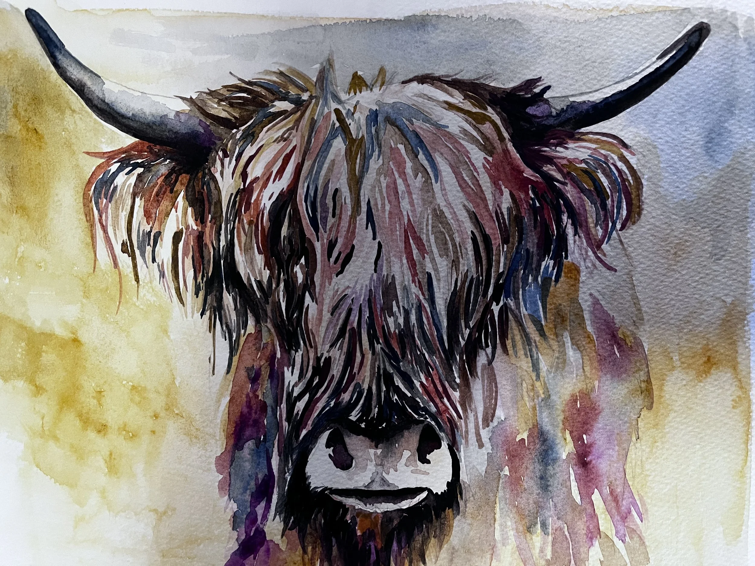 Watercolor painting of a Highland cow with long shaggy hair and large horns, standing against a yellow and purple background.