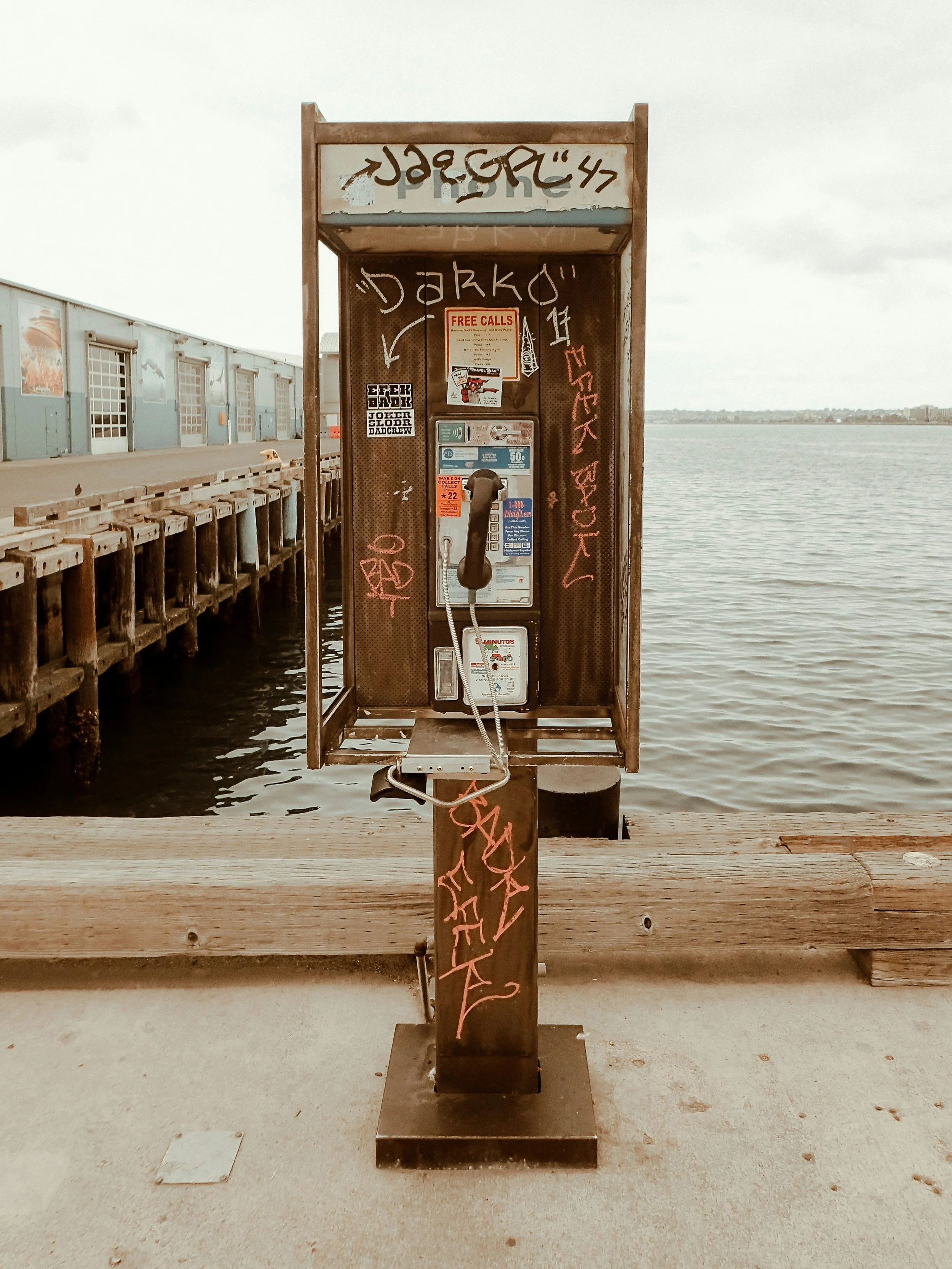 Old phone booth on the edge of a boardwalk