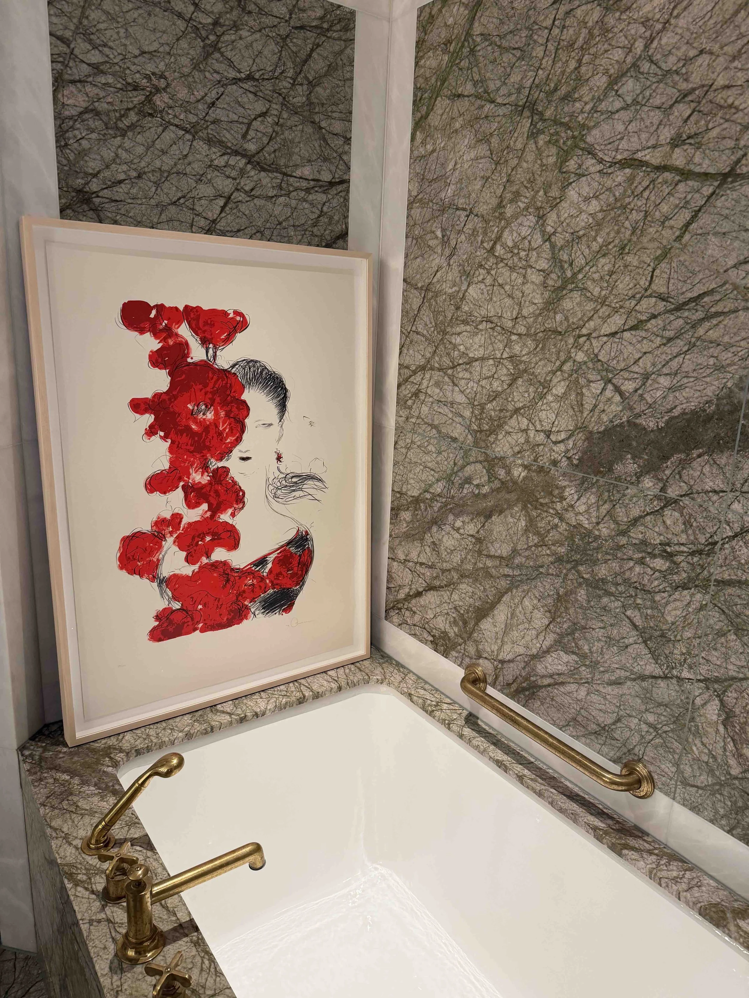 Contemporary artwork displayed beside a marble bath during London Invitational at The Chancery Rosewood.