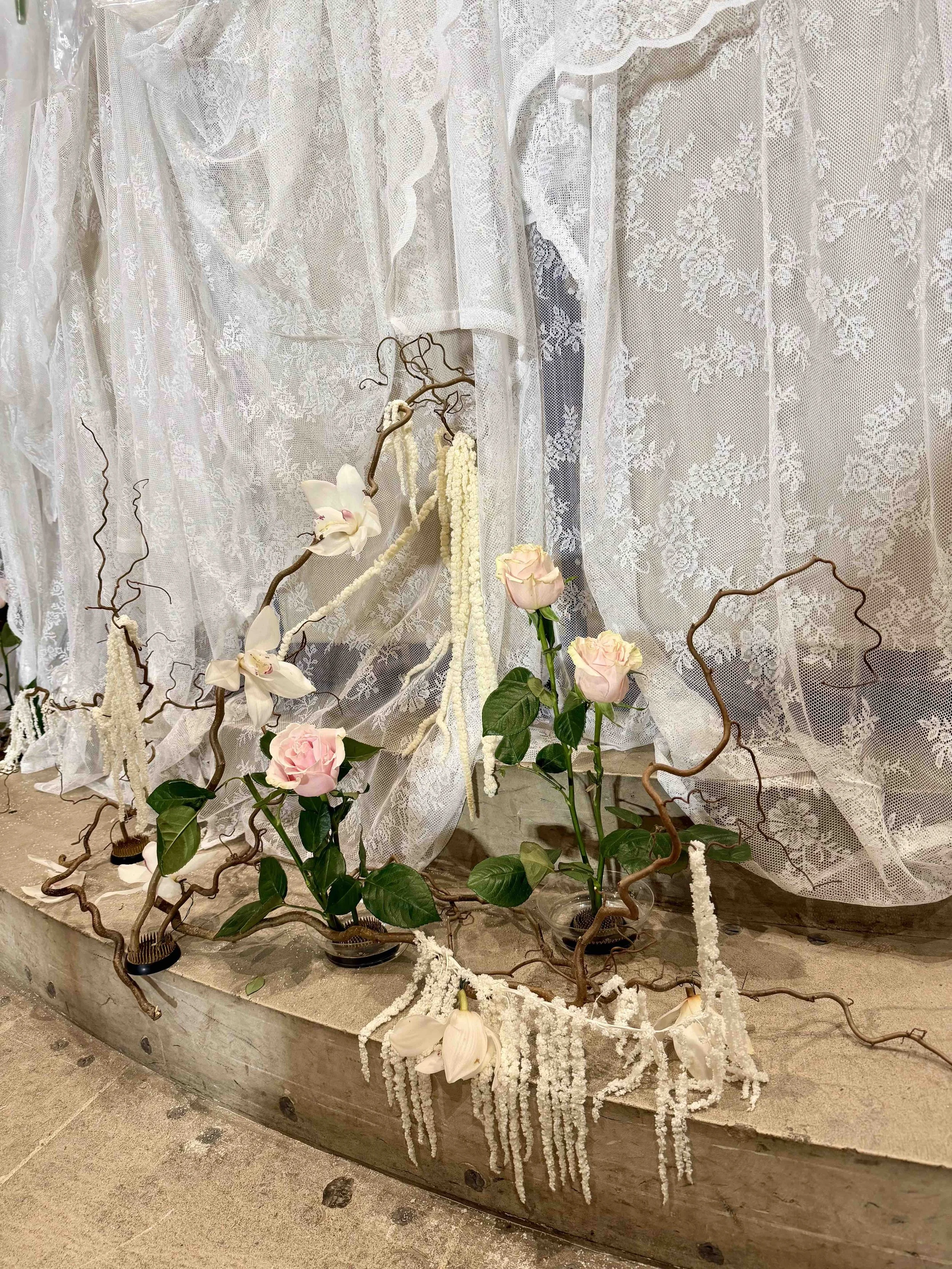 Pale roses, orchids, white lace and sculptural branches decorating the historic London church.