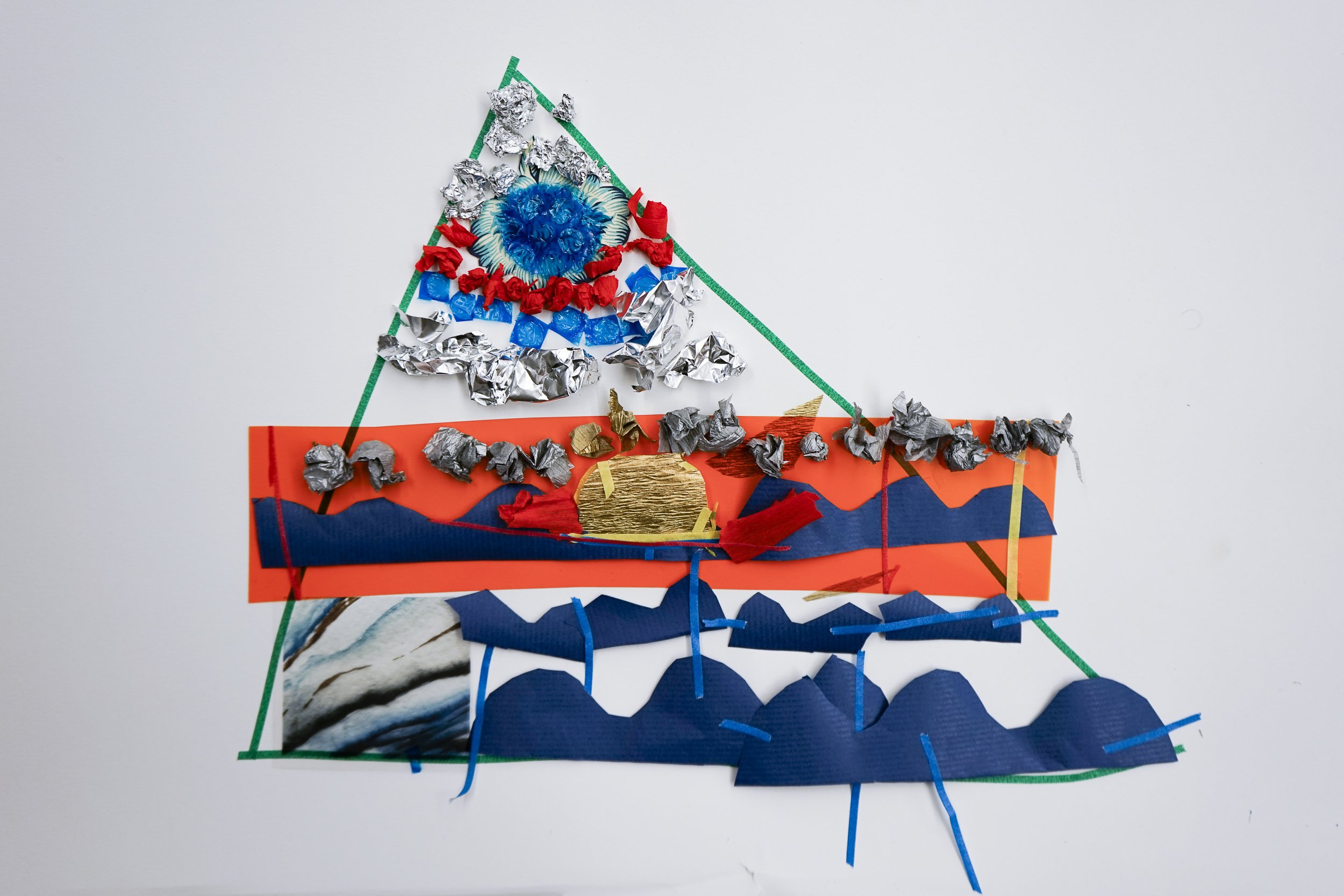A colorful abstract art piece made with various textured paper cutouts arranged on a white background. The composition includes a triangular shape, a tree or boat-like shape, clouds, mountains, and waves, using bright colors like blue, red, gold, sil