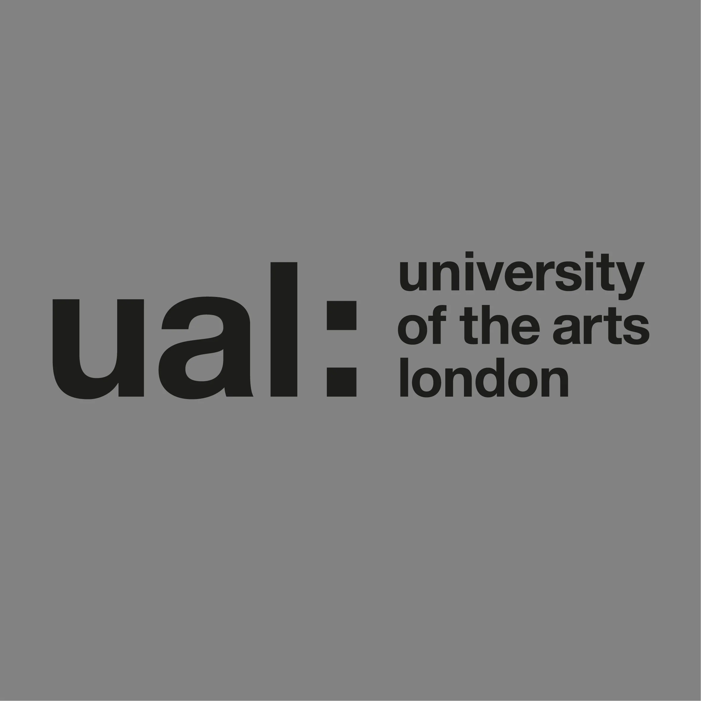 Close-up of a section of a gray wall with black text reading 'The university of the arts London'.