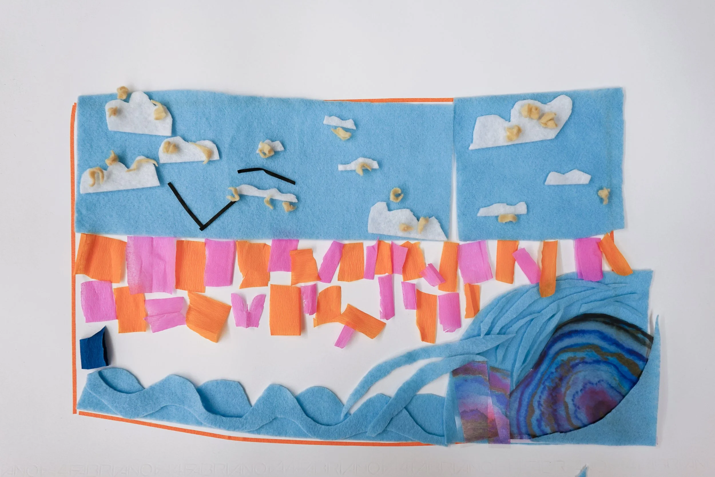 A craft project made of colored paper and small pieces of tissue paper on a white background. It includes a blue background with clouds, a rainbow, and a sun, with various shapes and colors of paper decorated on it.