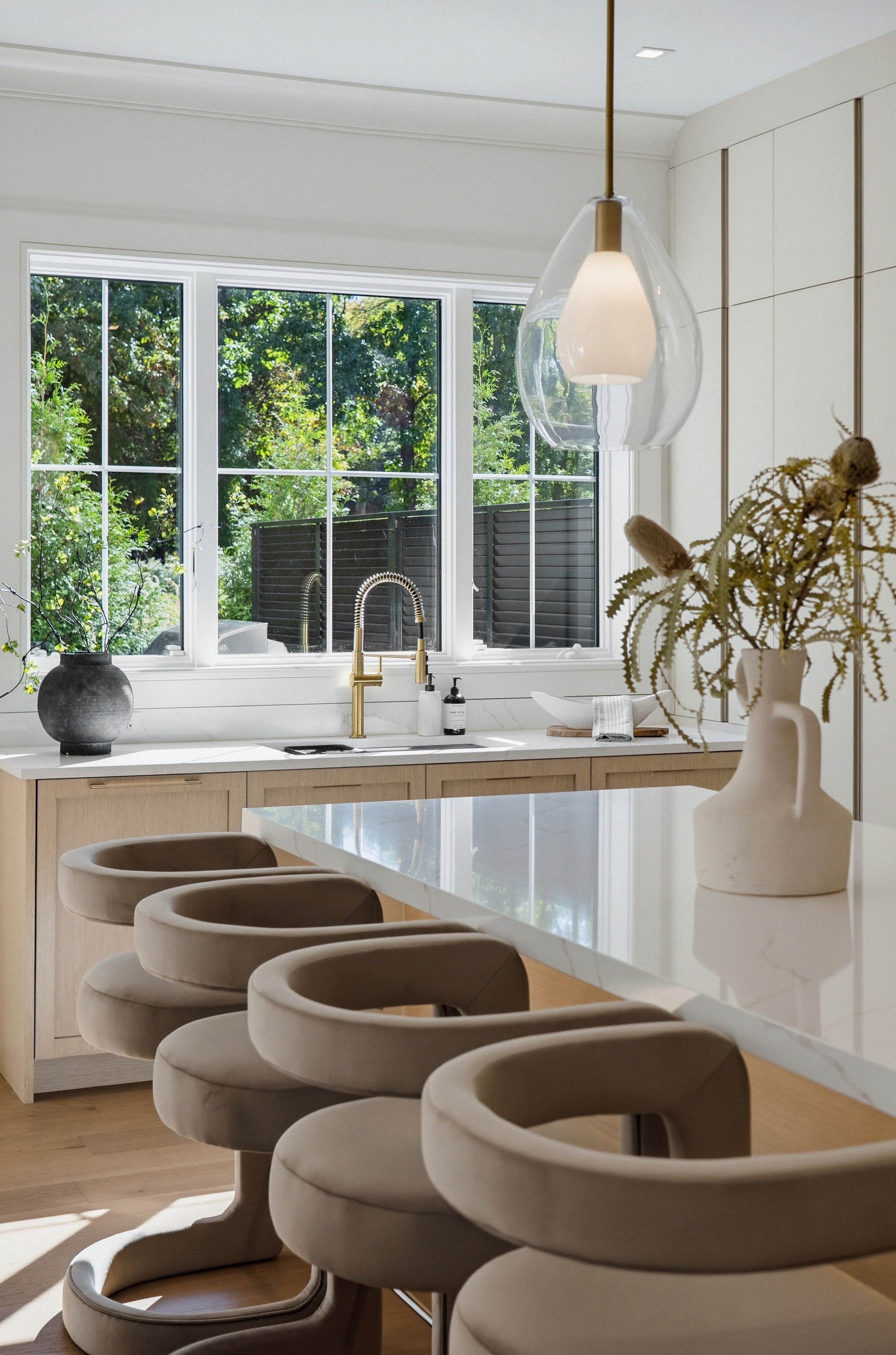 Signature palette kitchen with pale oak, Calacatta marble island and garden windows