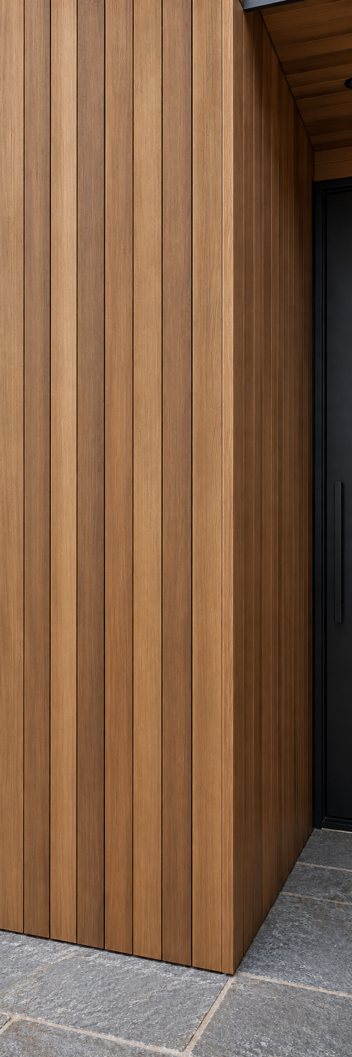 Clear vertical-grain thermally modified Western Hemlock cladding around a modern entryway.