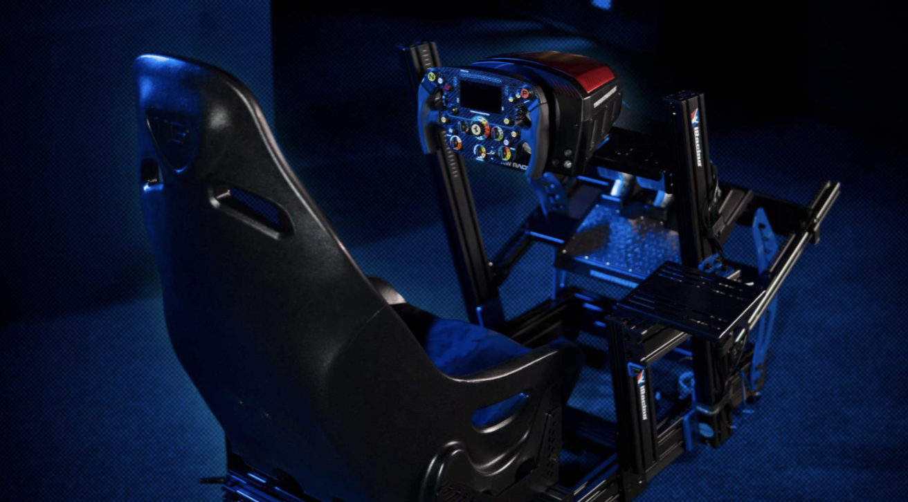 Racing simulator setup with a black racing seat and a blue racing wheel with multiple buttons, mounted on a black frame, illuminated by blue LED lights.