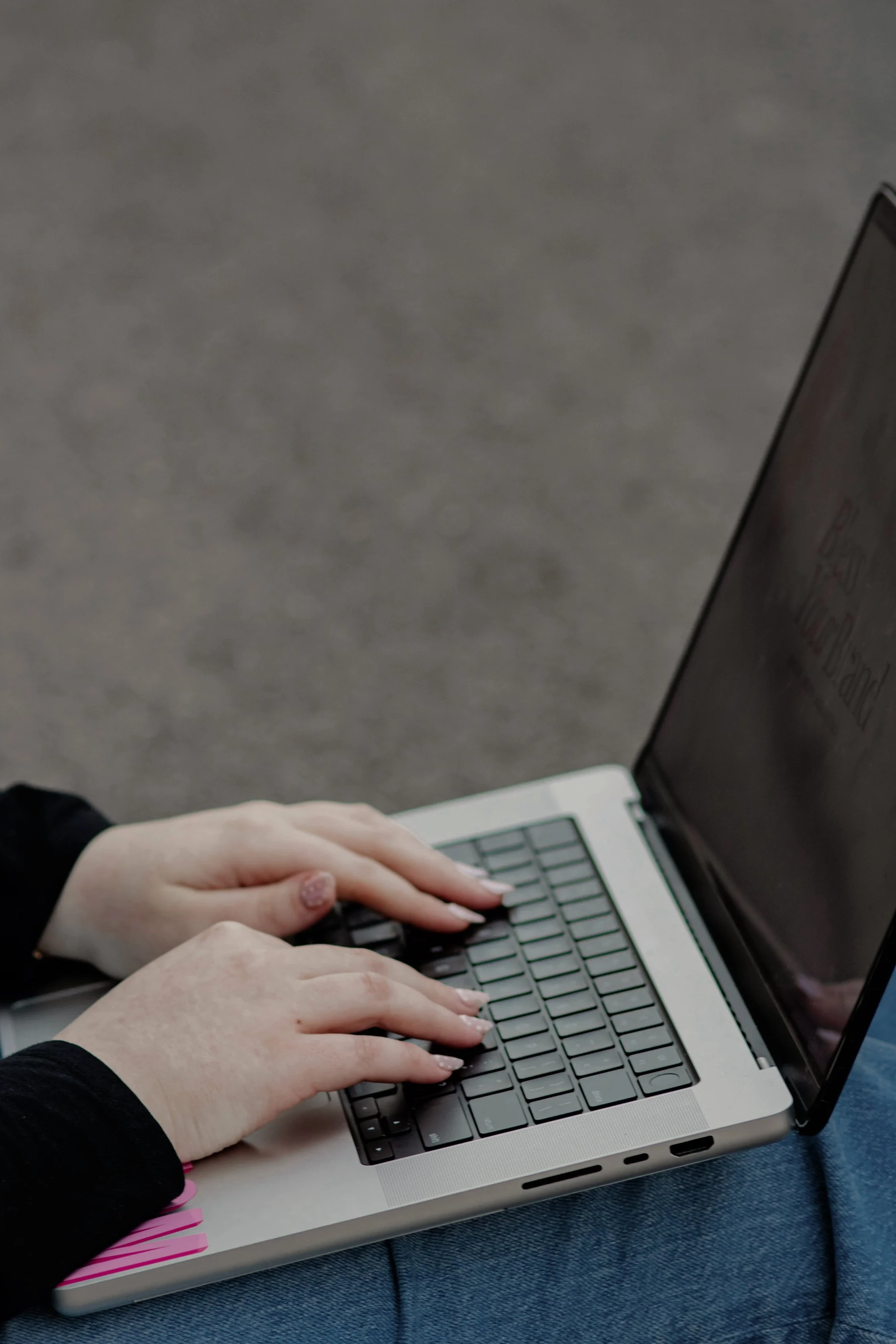 Person typing on a laptop keyboard