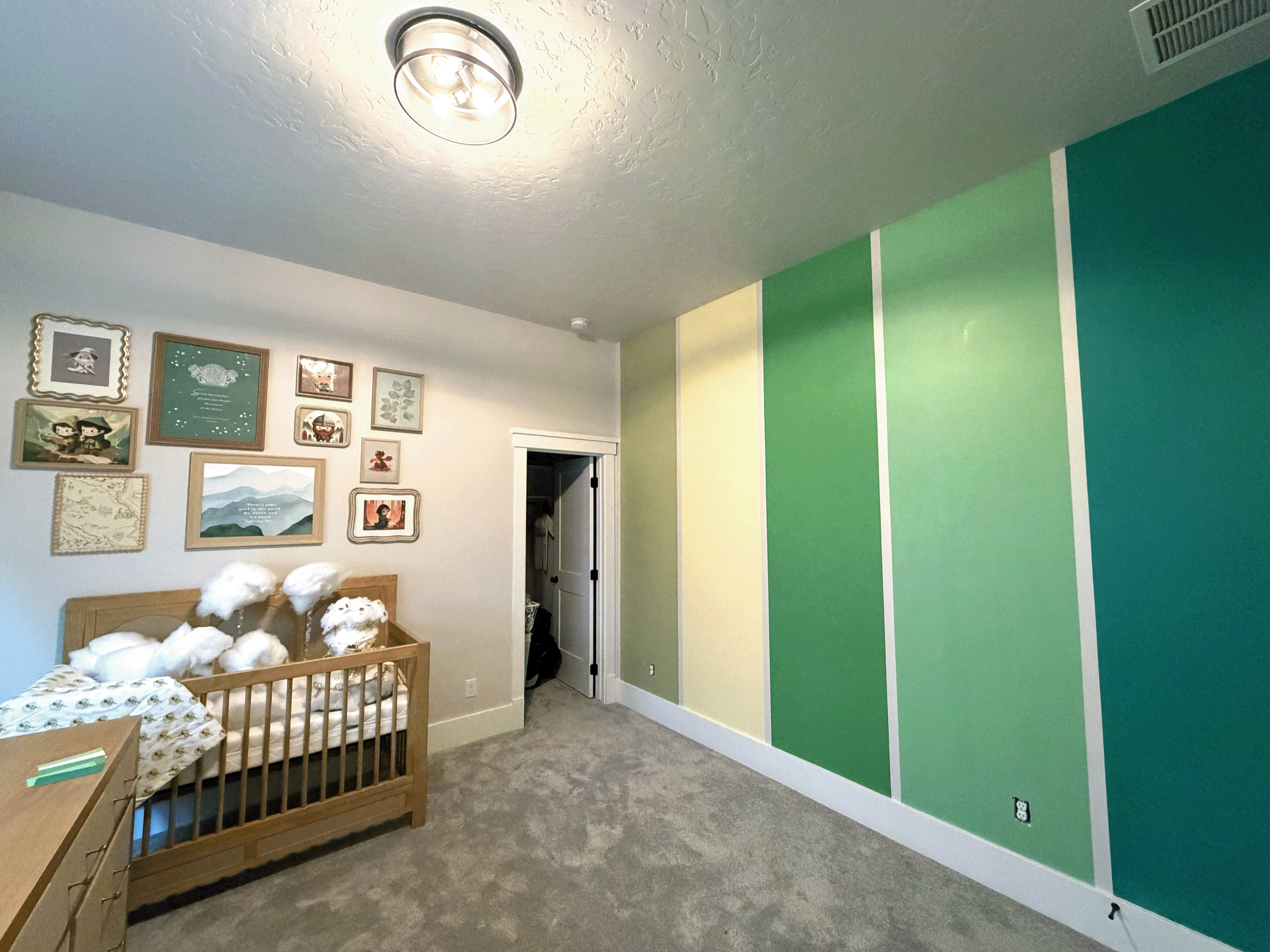 Interior nursery painting in Boise, Idaho. A green gradient vertical striped wall.