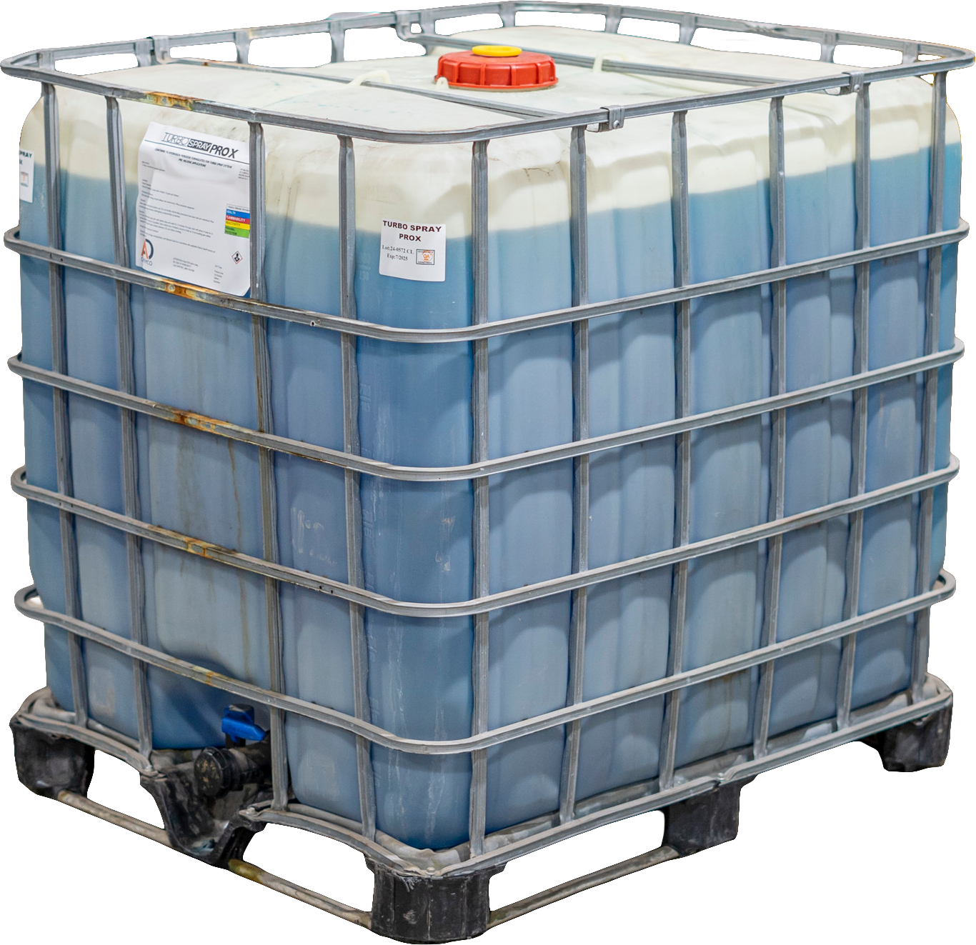 A large industrial plastic container filled with liquid, placed in a metal cage on a pallet. The container has a red screw cap and a label that reads 'Turbo Spray ProX'.