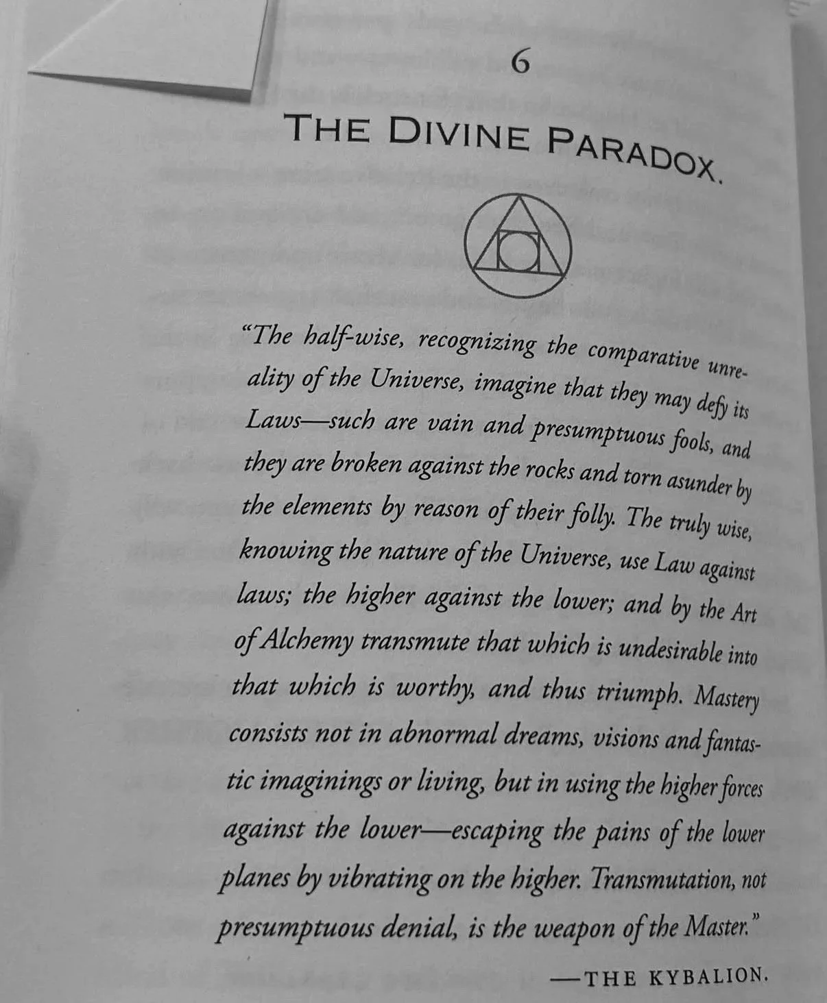 Page from a book titled 'The Divine Paradox' with a diagram of a geometric symbol.