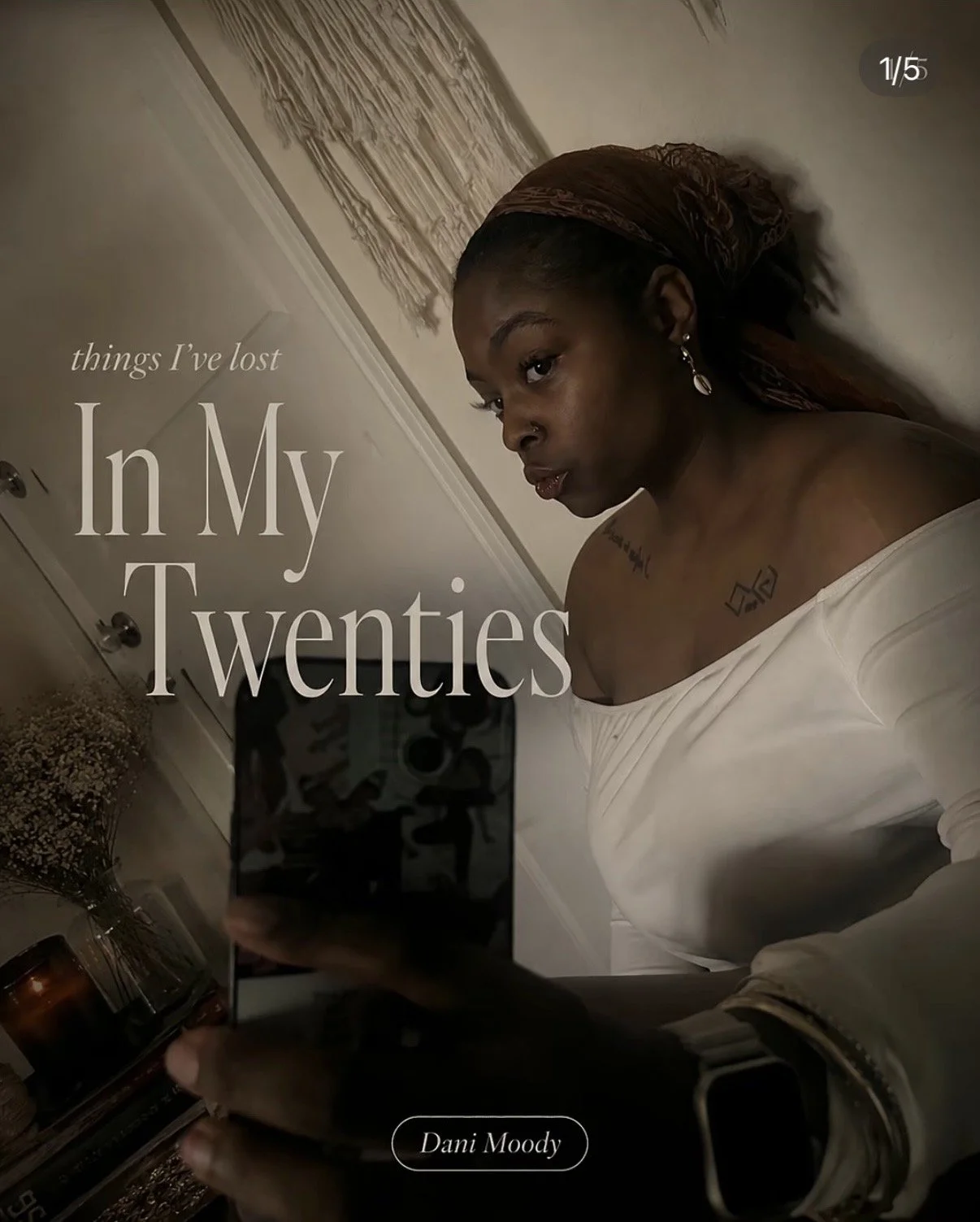 A woman with dark skin, wearing an off-the-shoulder white top and earrings, takes a mirror selfie in a dimly lit room with a beige wall, a macramé wall hanging, and dried flowers. Text on the image reads: 'things I've lost In My Twenties' and 'Dani Moody' at the bottom.