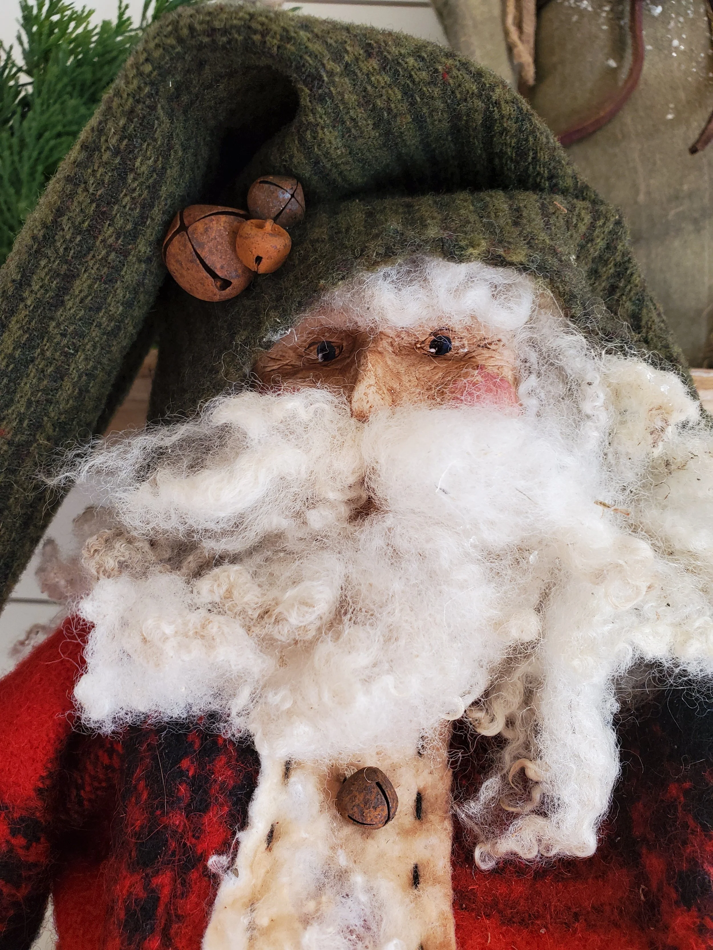 Handcrafted Old World Santa with a green wool hat, rusty bells and a full curly white beard.