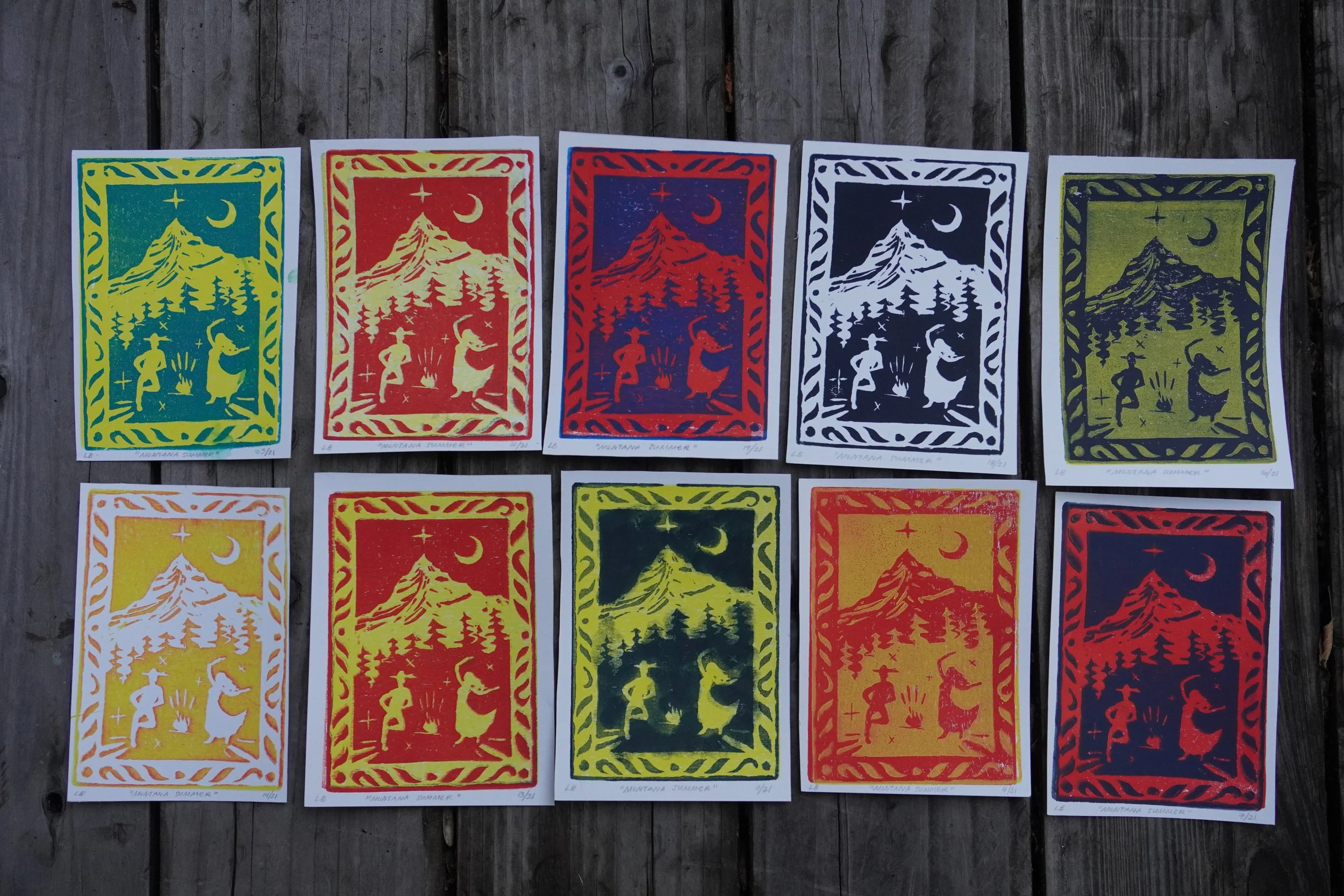 Colorful linocut prints depicting a mountain, pine trees, crescent moon, stars, and camping figures.
