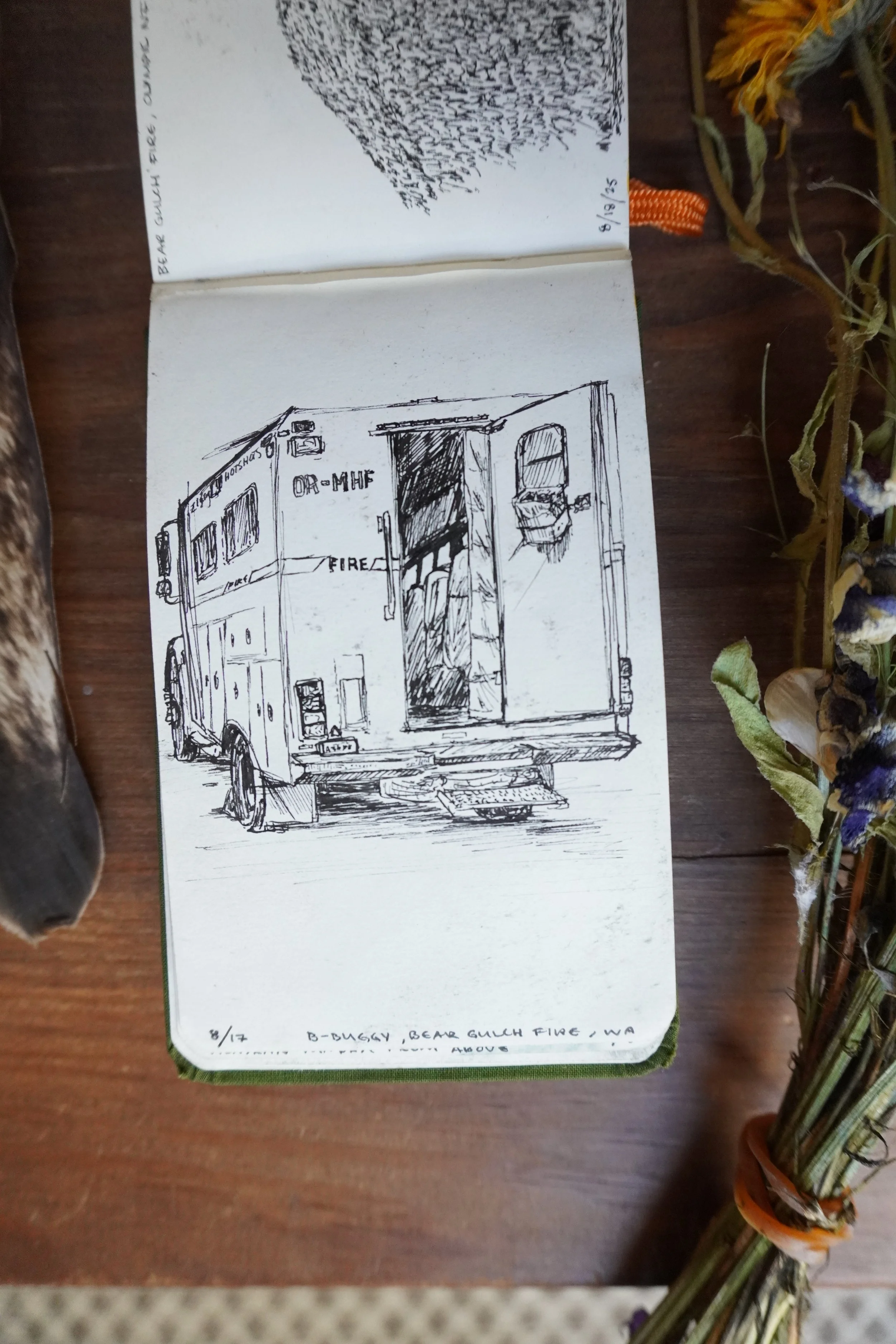 Open sketchbook showing a hand-drawn fire personelle carrier. 
