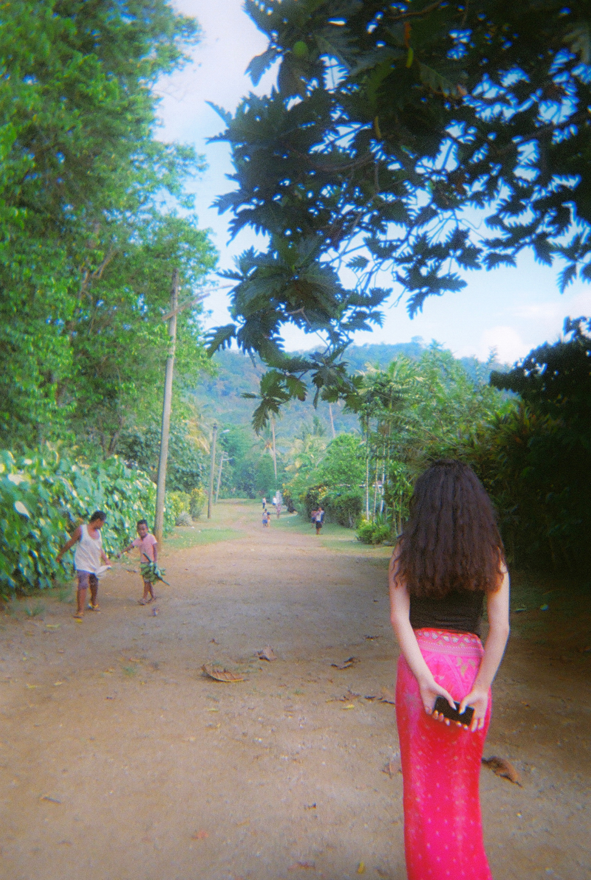 MANZIL 015: STOMPING GROUNDS

I took this photo of my friend Ali back in 2023 when her and I visited my childhood home back in Samoa. This is the street I grew up in, my old stomping grounds.
- Barbara 