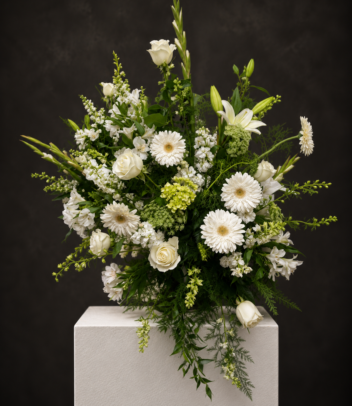 Elegant White Floral Arrangement on Pedestal.png