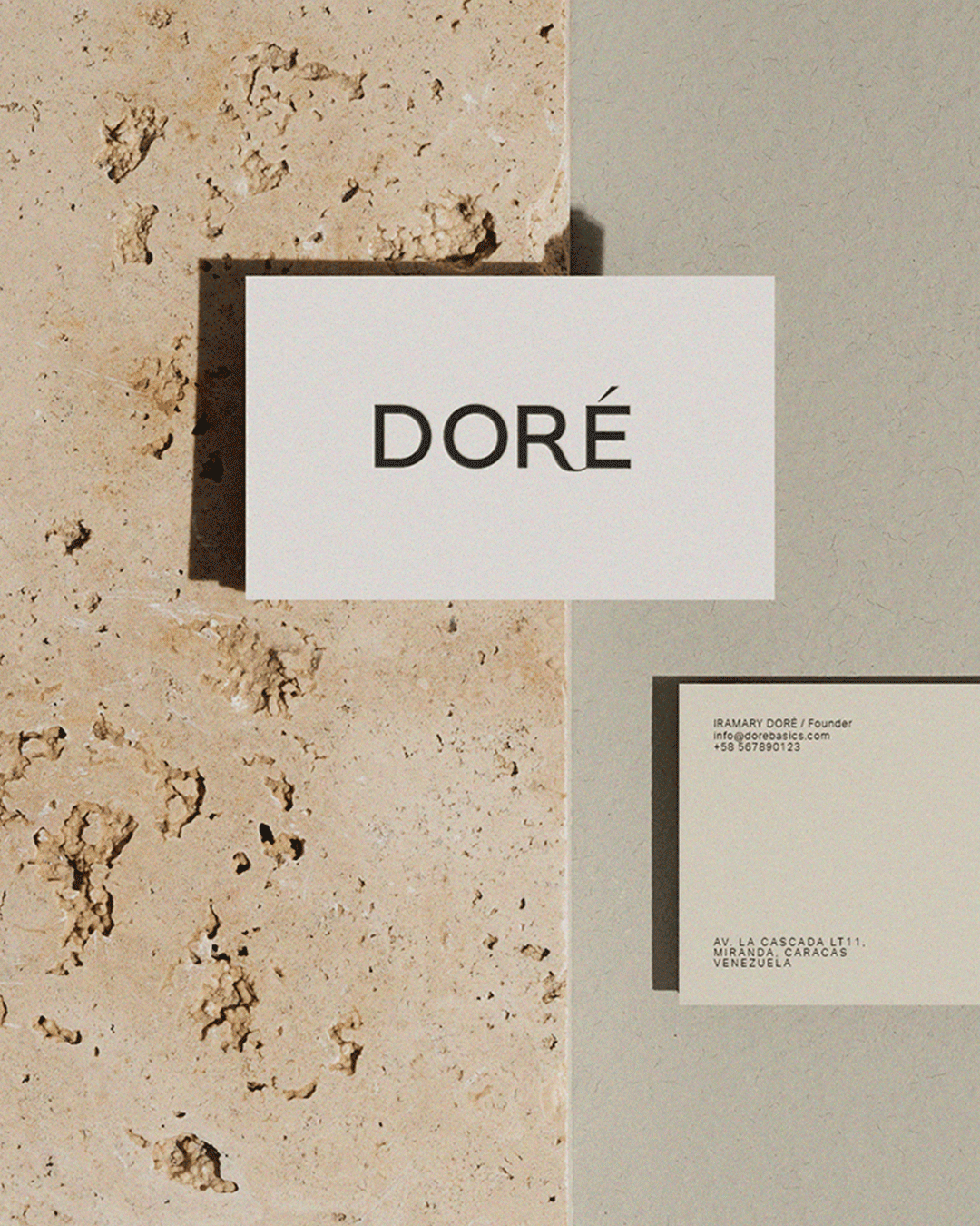 DORÉ sustainable fashion brand identity by Sara Vera, featuring minimalist business cards with bold black typography on contrasting textured surfaces.