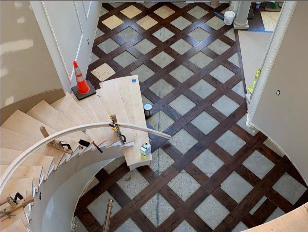 Decorative wood flooring with a geometric inlay pattern.