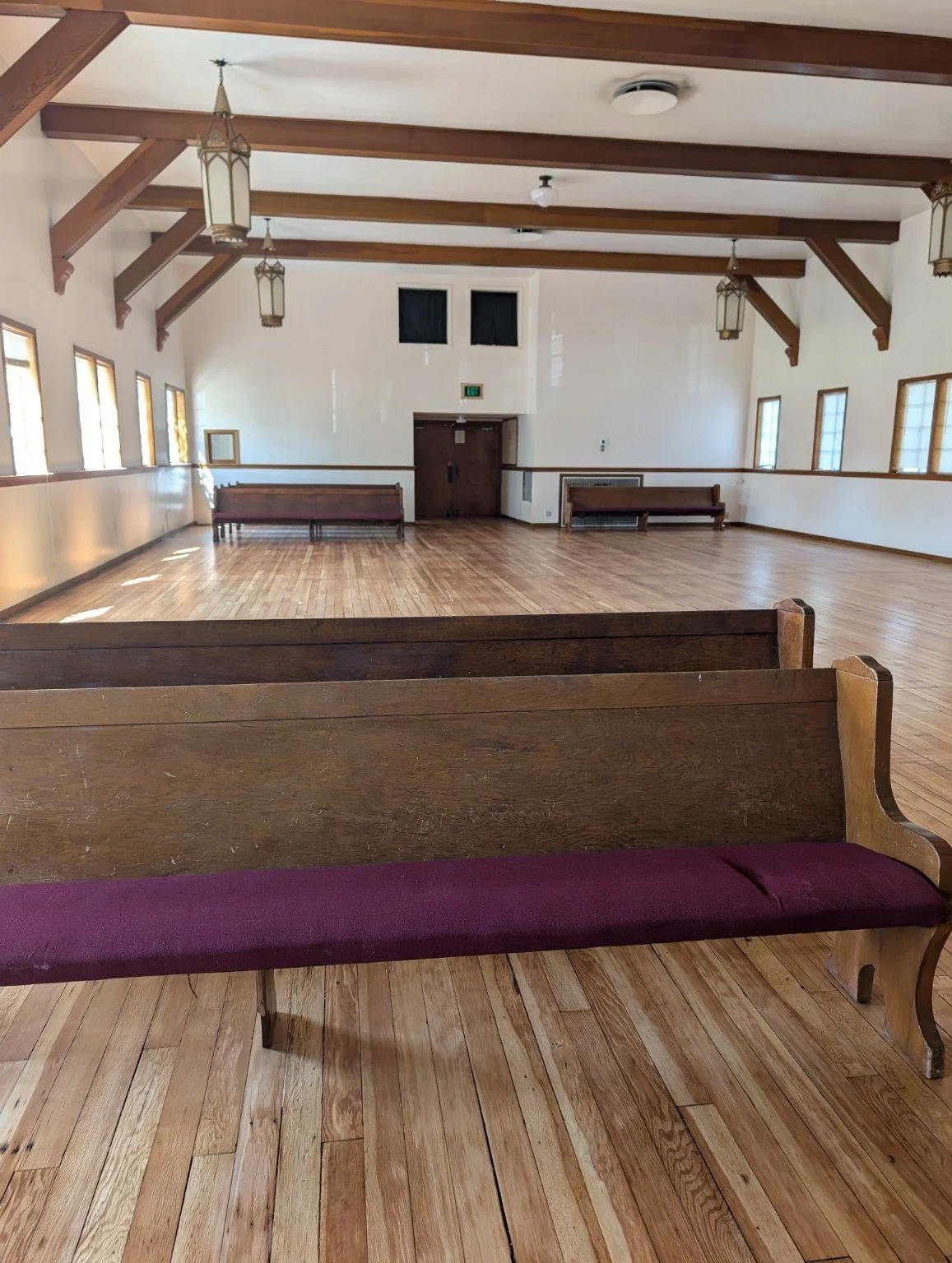 Church hardwood restoration — restored floor detail and hall view.