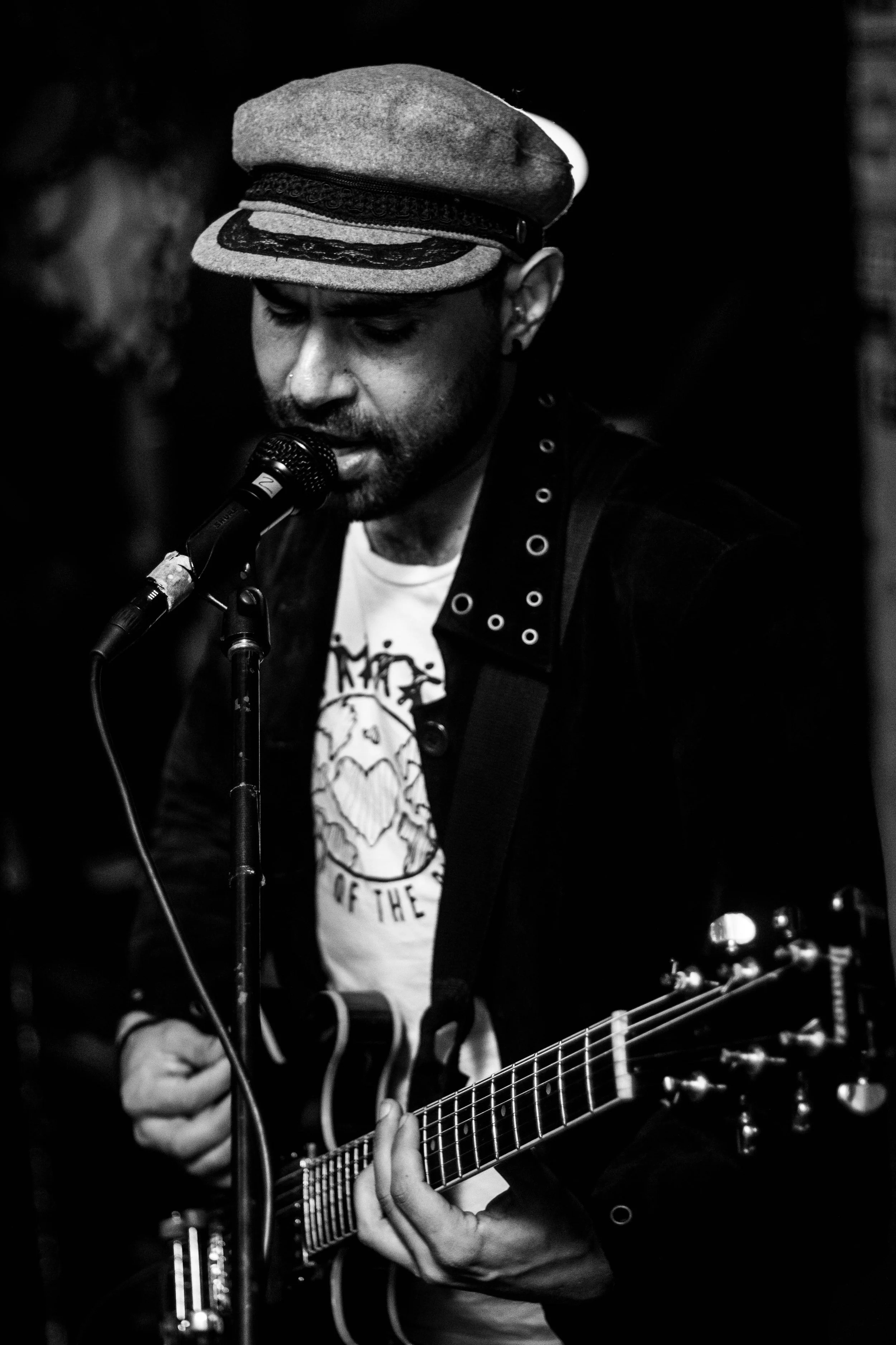 Dan Romeo performing live on electric guitar at a Sydney event