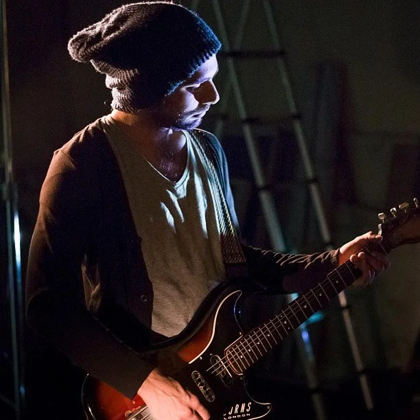 Dan Romeo playing a Burns guitar in a video shoot