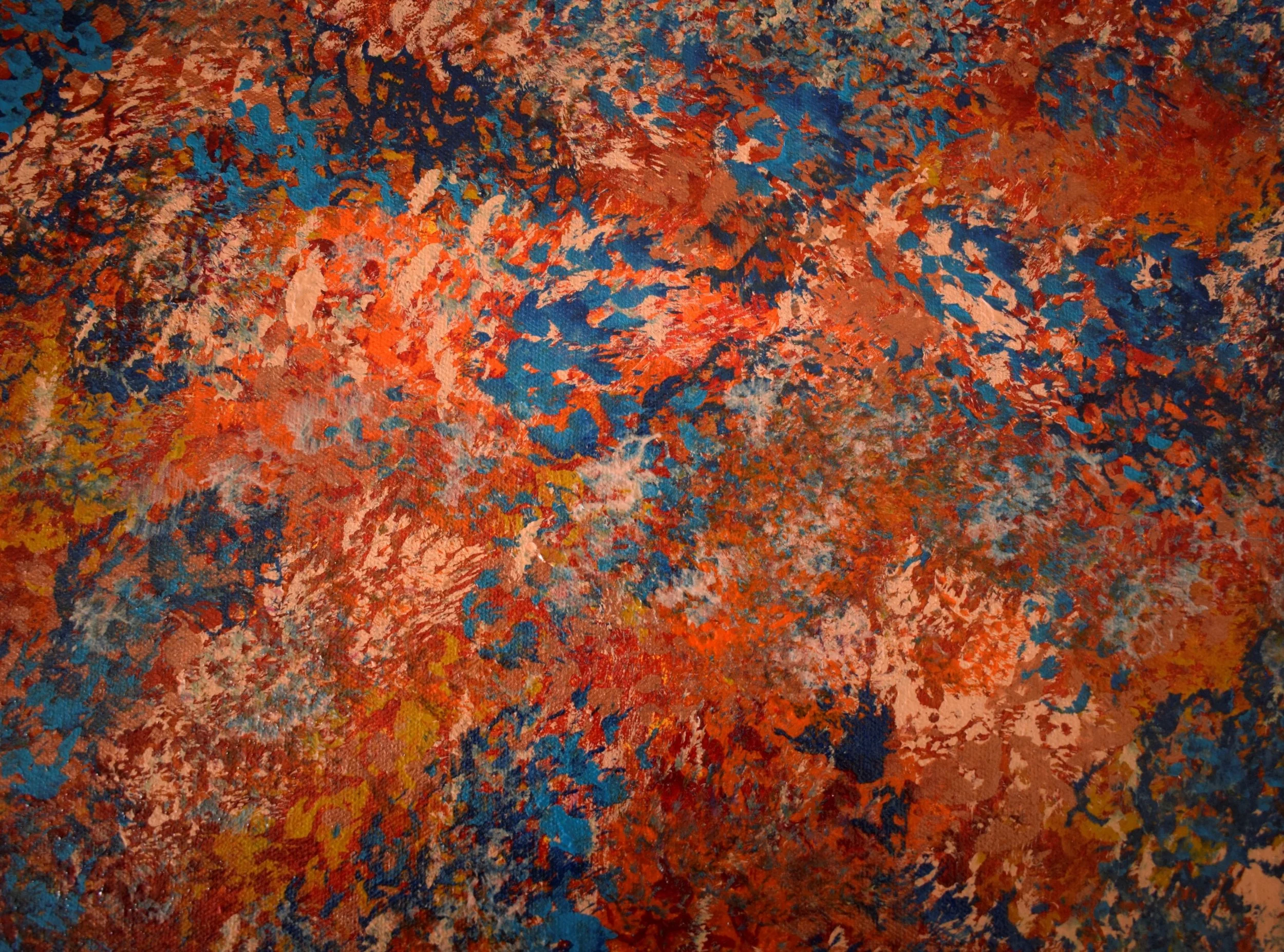 Close-up of a brightly colored abstract painting with shades of red, orange, blue, yellow, and pink