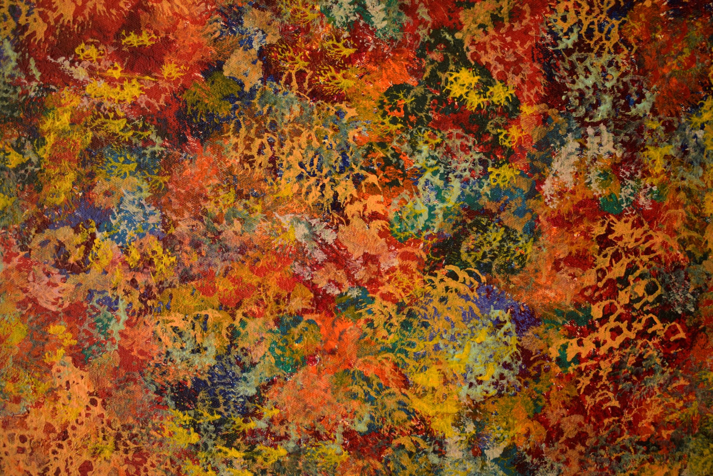 Abstract painting with vibrant splashes of red, yellow, orange, blue, green, and purple colors.
