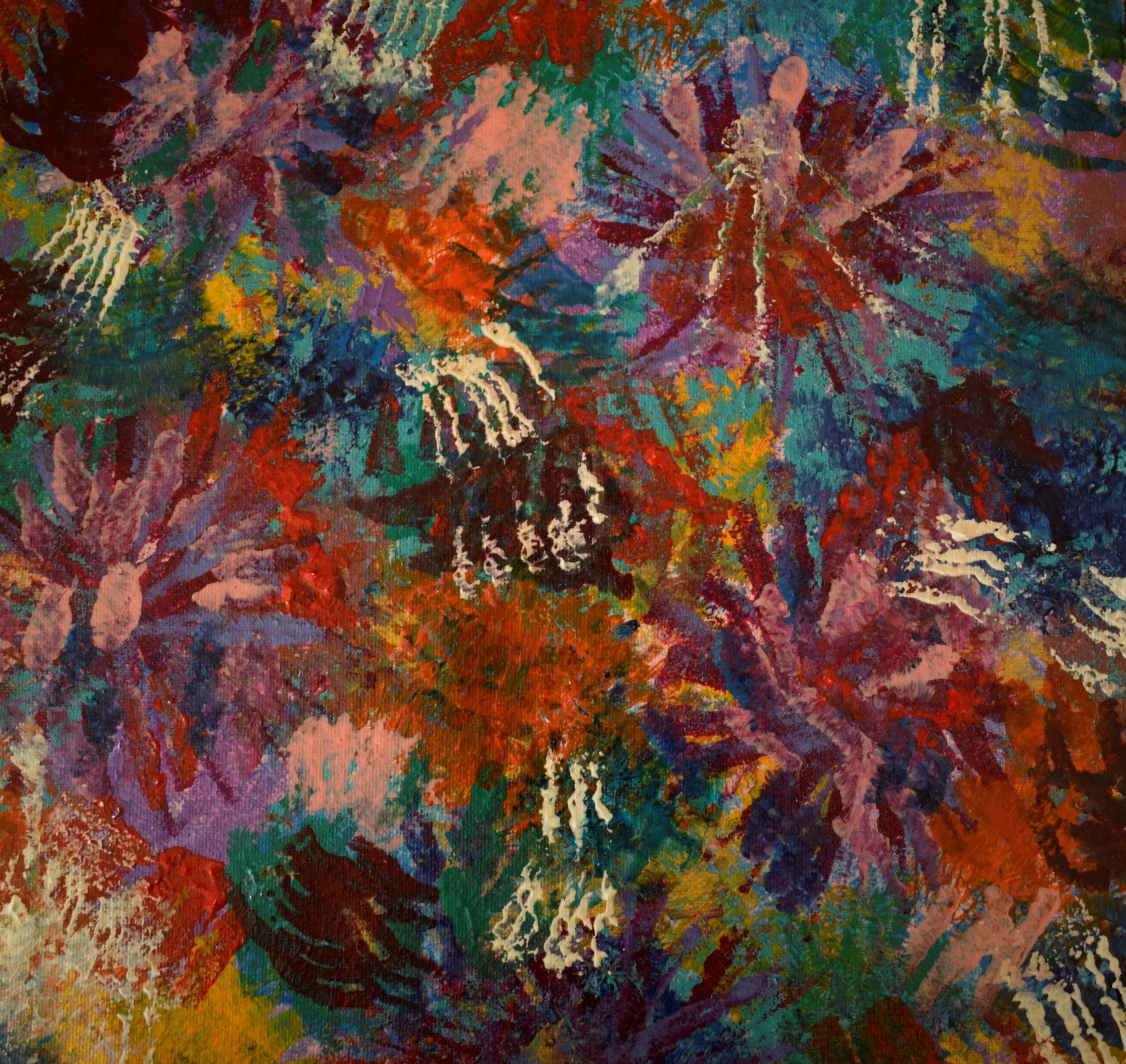 Close-up of a colorful abstract painting with splashes of red, purple, green, yellow, white, and blue paint on canvas.