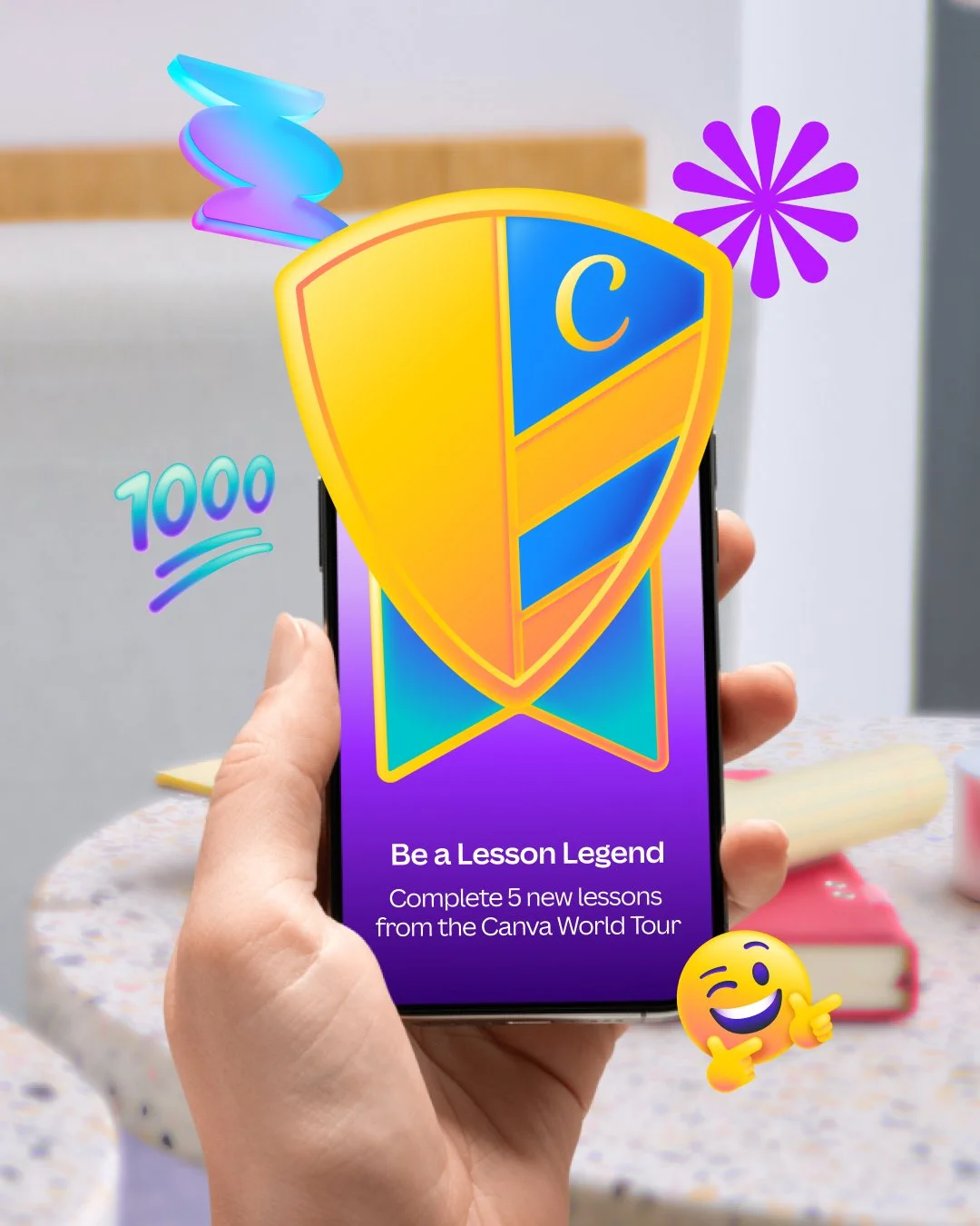 Hand holding a smartphone displaying a colorful Canva World Tour lesson banner reading “Be a Lesson Legend” and “Complete 5 new lessons,” with decorative graphics and a 1000-point badge.