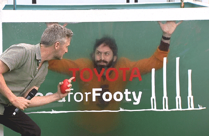 Two men in front of a green Toyota for Footy promotional backdrop