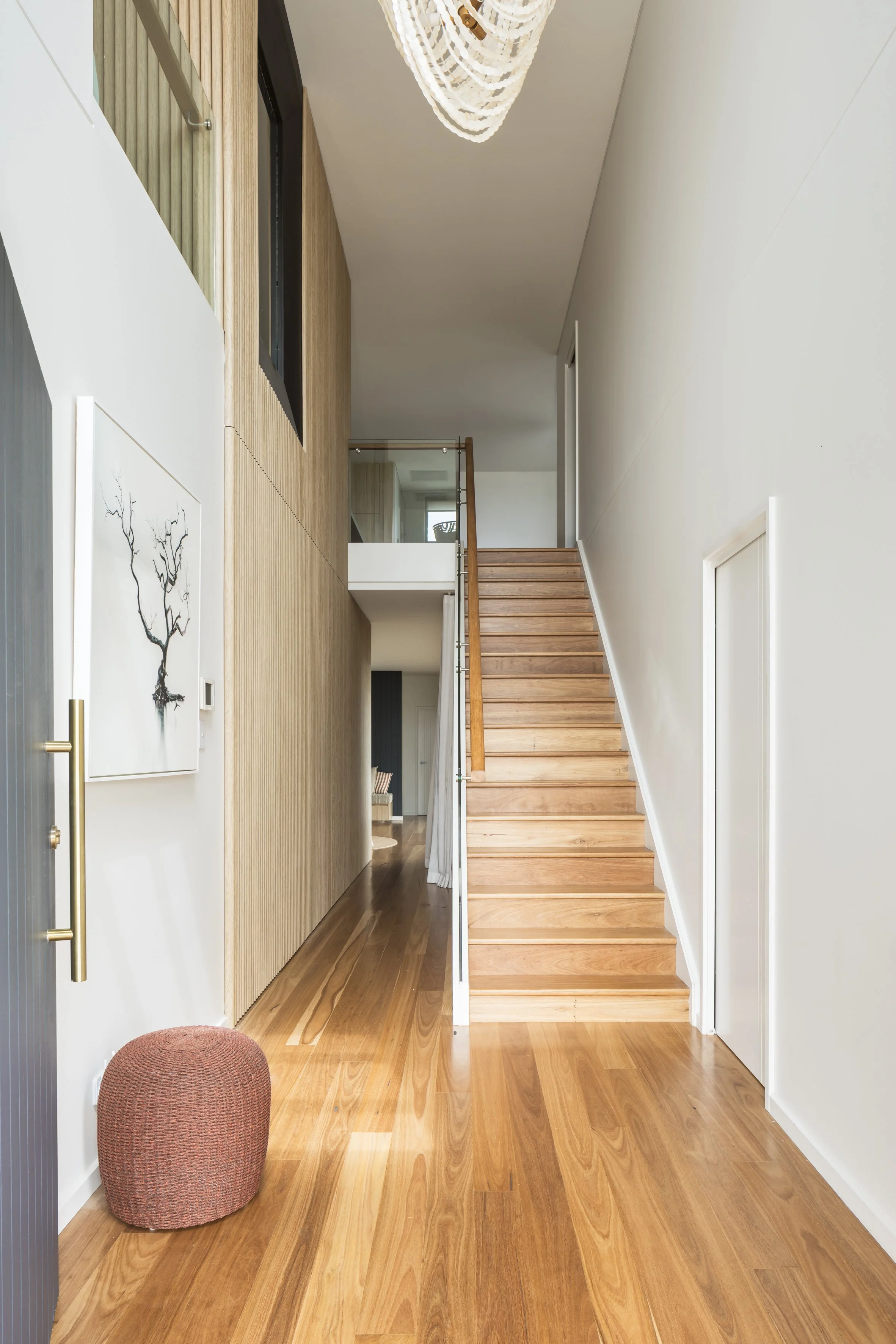 Entry with fluted timber wall and timber staircase, Shell Cove